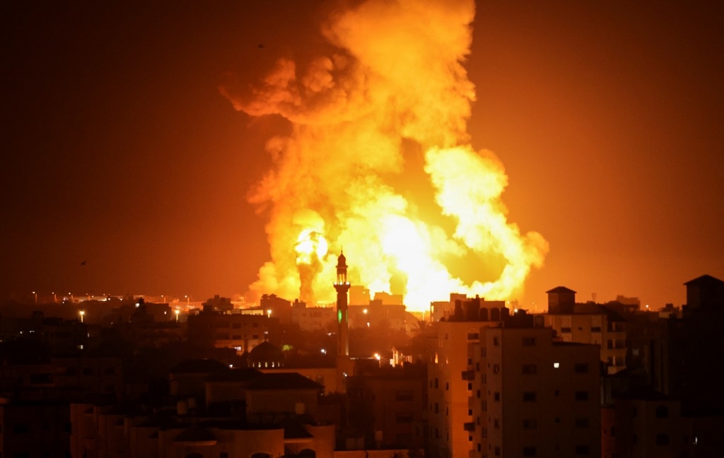 Fires are seen following an Israeli air strike in Gaza city on 16 July 2022 (AFP)