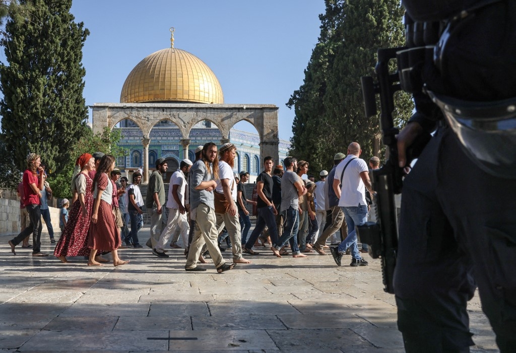 Israeli forces protect Israeli settlers storming al-Aqsa Mosque on 7 August 2022 (AFP)