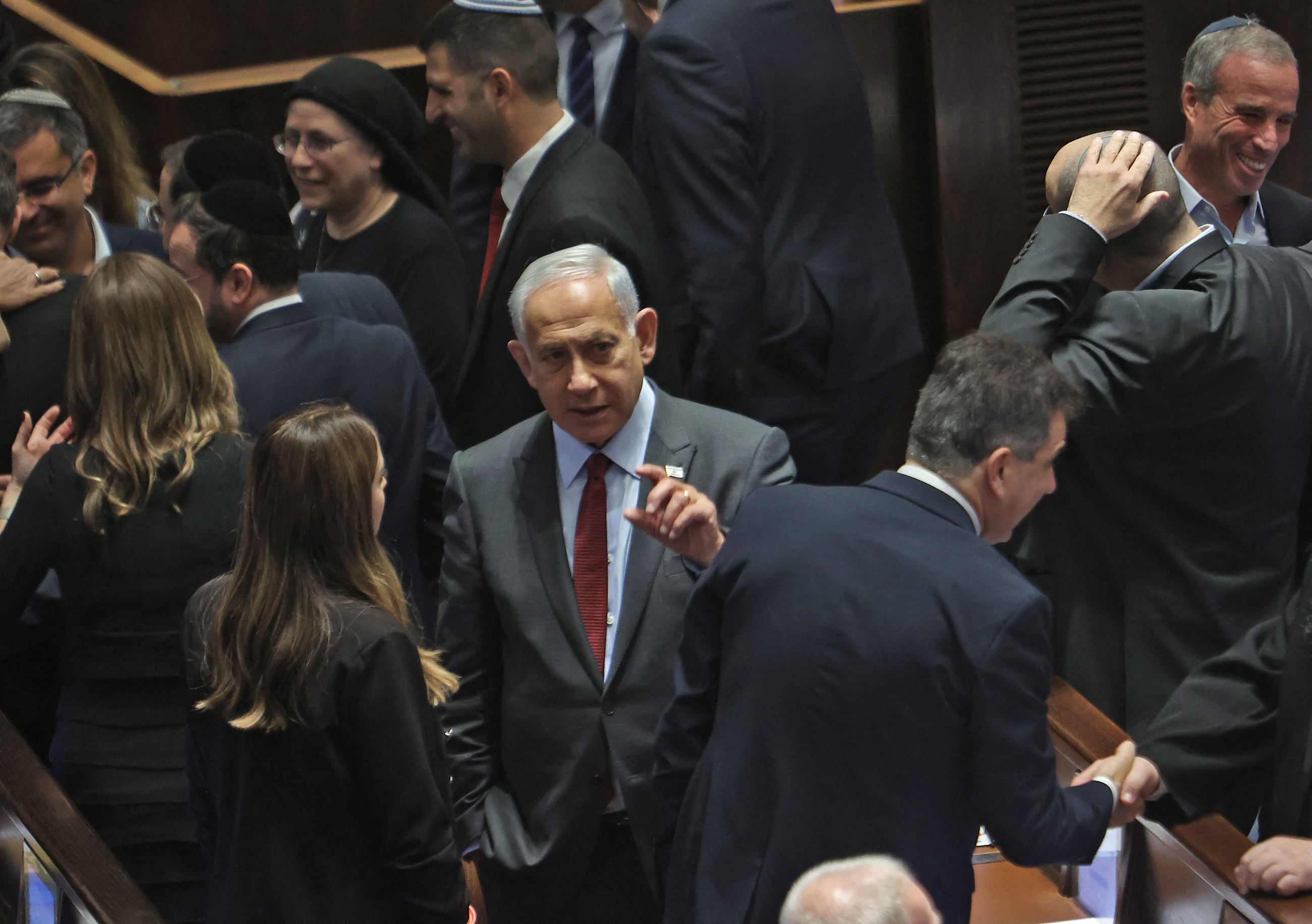 Israeli prime minister-designate Benjamin Netanyahu (C) attends a session to elect the new speaker of the Knesset (Israeli parliament) at its Plenum Hall in Jerusalem on December 13, 2022 (AFP)