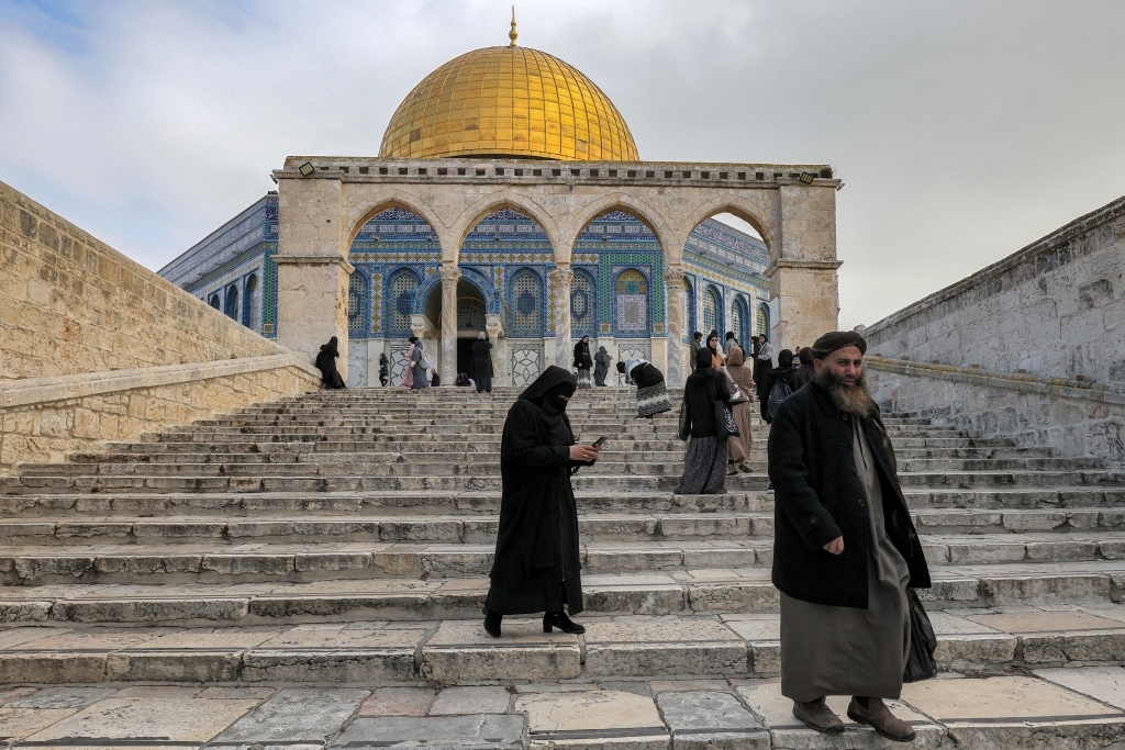 People descend steps as they walk away from the Dome of the Rock shrine at Al-Aqsa mosque compound (also known as the Temple Mount complex to Jews) in the old city of Jerusalem on January 3, 2023 (AFP)