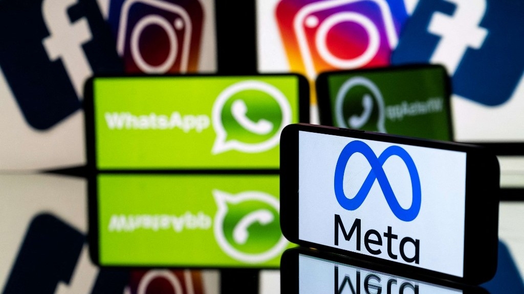 A smartphone and a computer screen displaying the logos of Instagram, Facebook, WhatsApp and their parent company Meta (AFP)