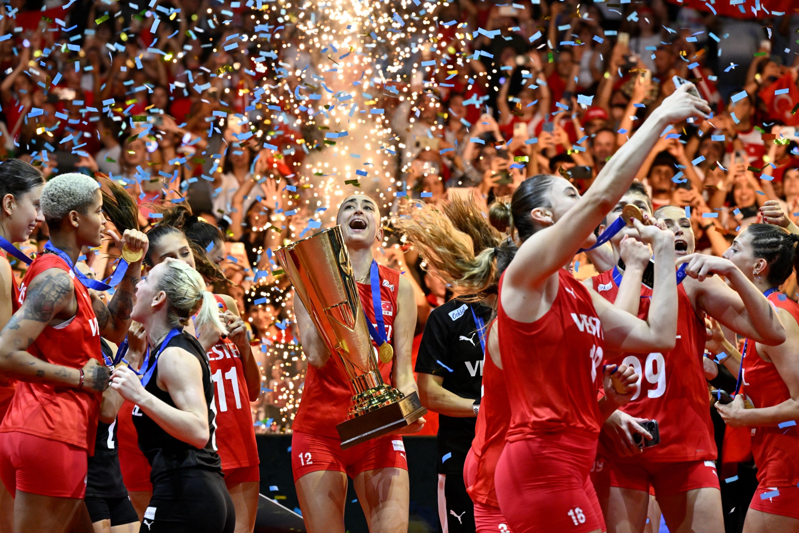 Turkey's team players celebrate their victory after winning the Women's EuroVolley 2023 final volleyball match against Serbia, in Brussels on 3 September 2023 (AFP)