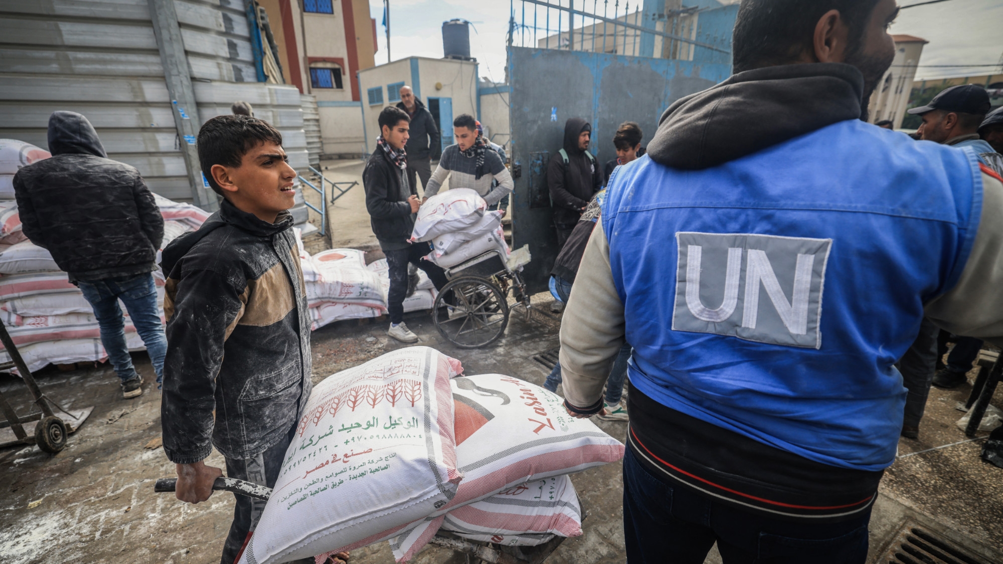 Displaced Palestinians receive food aid at the United Nations Relief and Works Agency for Palestine Refugees (Unrwa) centre in Rafah in the southern Gaza Strip on 28 January 2024 (AFP)