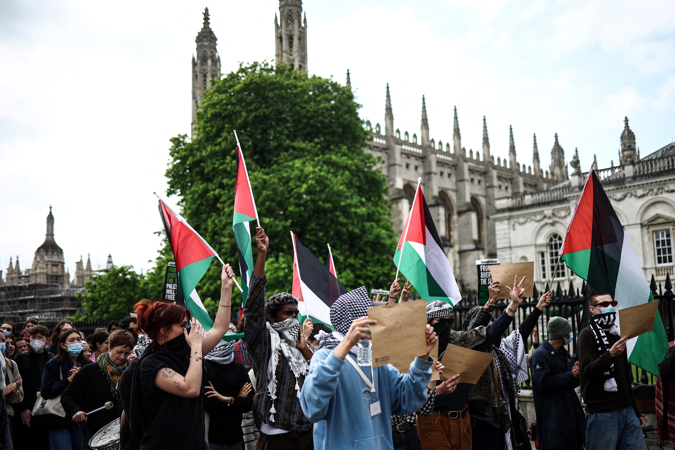 Students wave Palestinian flags next to Cambridge's iconic Senate House (AFP)