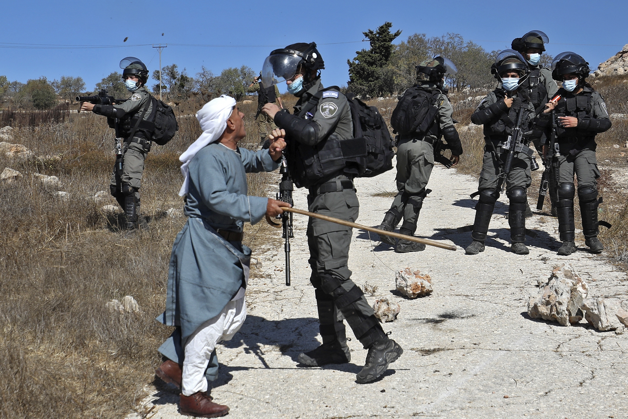 A Palestinian man confronts a member of the Israeli security forces 
