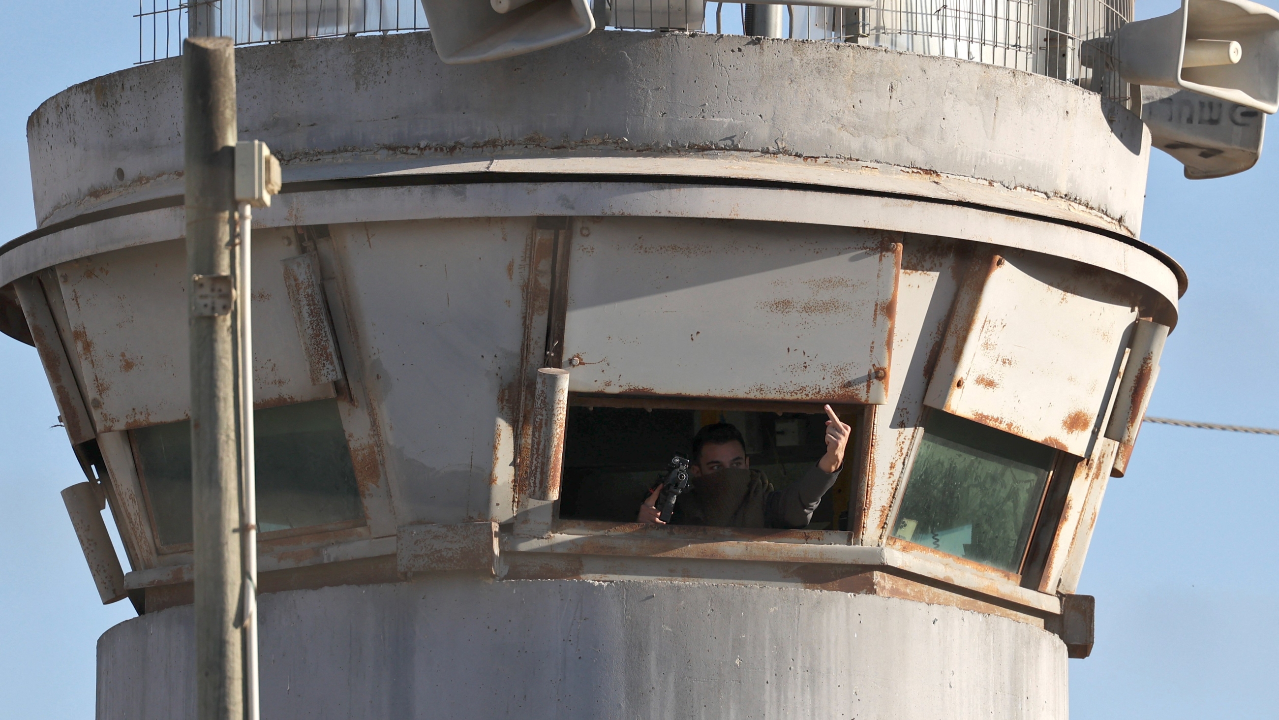 An Israeli soldier gestures from inside a watch tower at Israel's Ofer prison near the city of Ramallah in the occupied West Bank, on 12 July 2021 (AFP) 