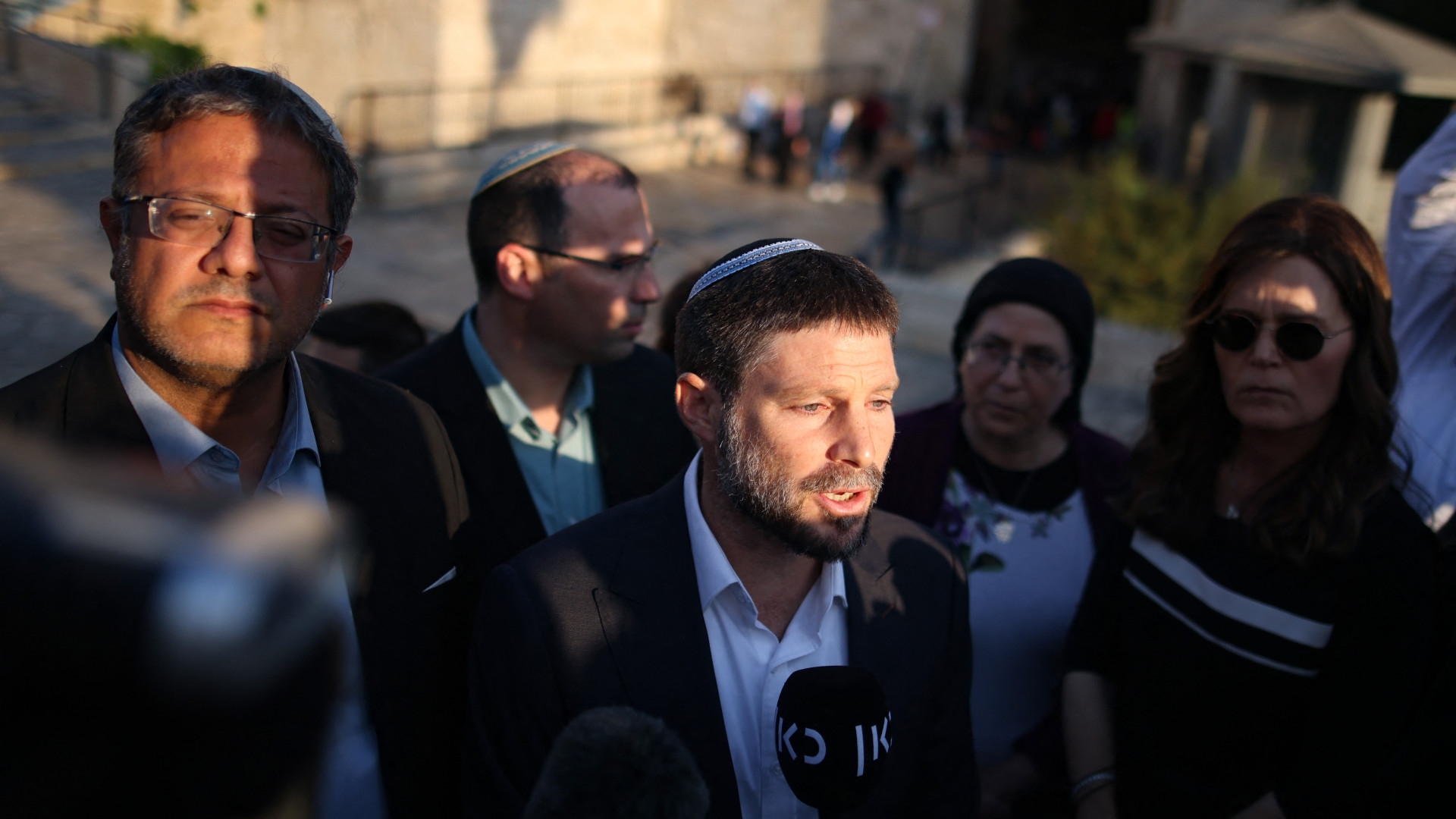 Member of the Knesset (Israel's parliament) from Religious Zionism parties, Bezalel Smotrich speaks to a journalist as fellow Knesset member Itamar Ben Gvir (L) looks on, outside the Damascus Gate in Jerusalem, on 20 October, 2021 (AFP)