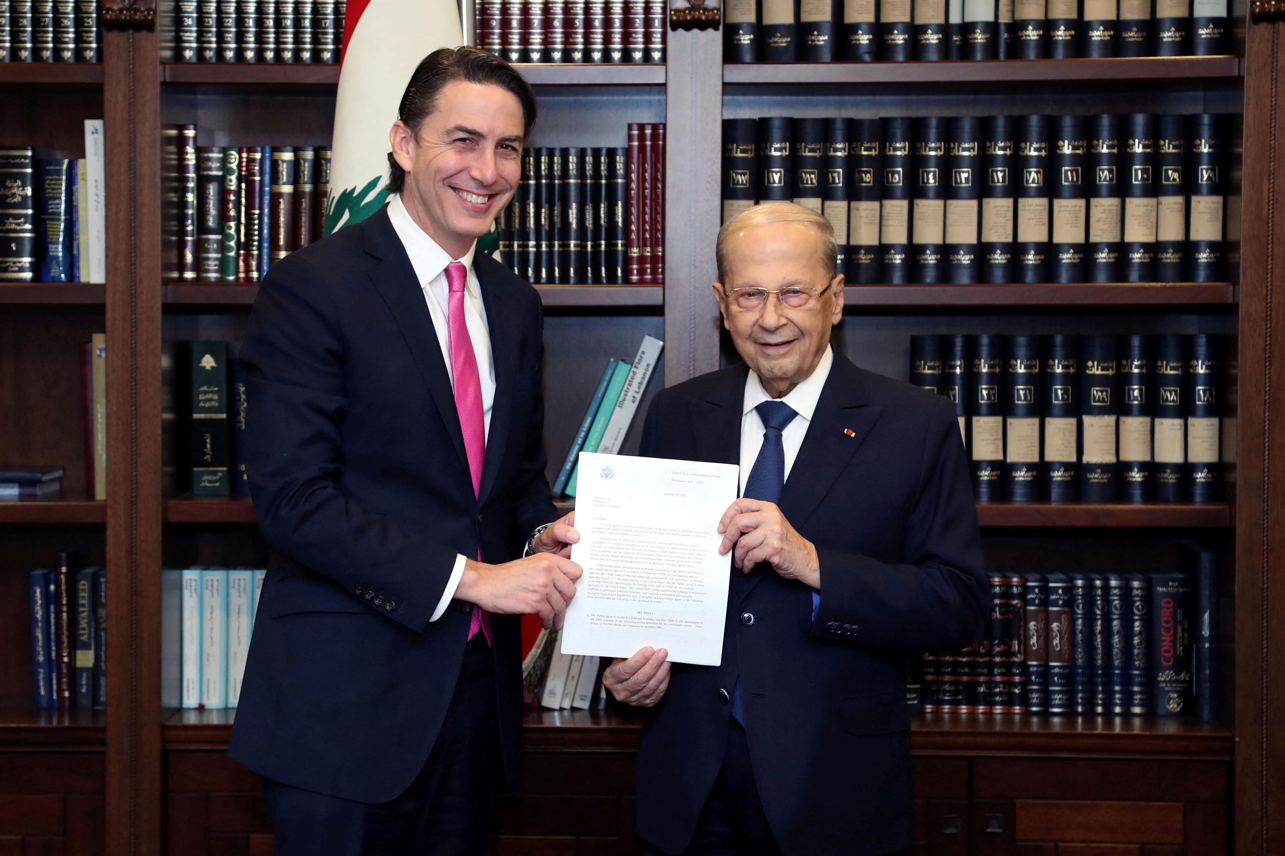 US mediatorAmos Hochstein and Lebanon's President Michel Aoun pose for a picture as they hold a letter at the presidential palace in Baabda, Lebanon 27 October 2022 (Reuters)