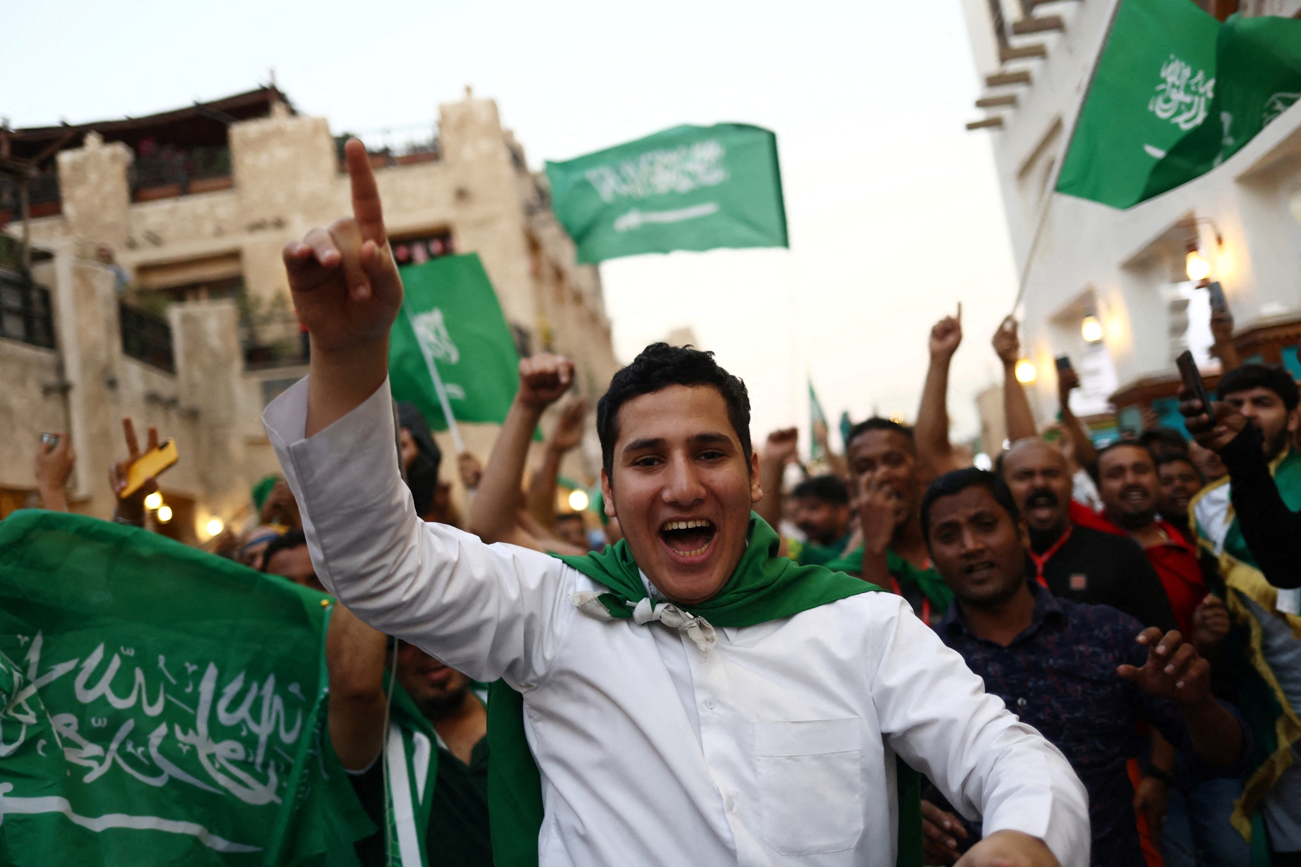Saudi Arabia fans celebrate in Doha's Souq Waqif after the match between Saudi Arabia and Argentina on 22 November 2022 (Reuters)