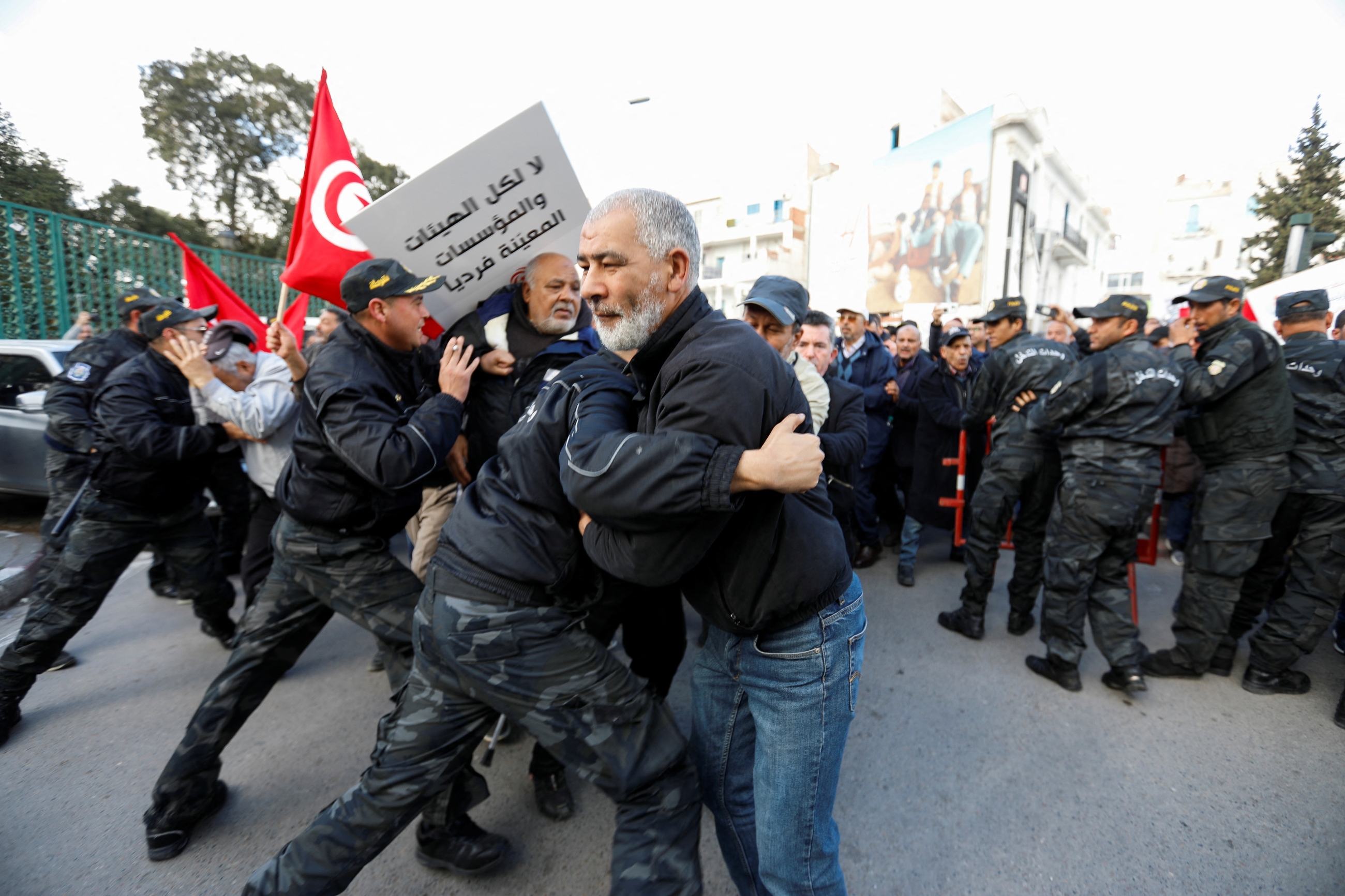 Police clash with demonstrators during a protest against Tunisian President Kais Saied, on the anniversary of the 2011 uprising, in Tunis, 14 January 2023 (Reuters)