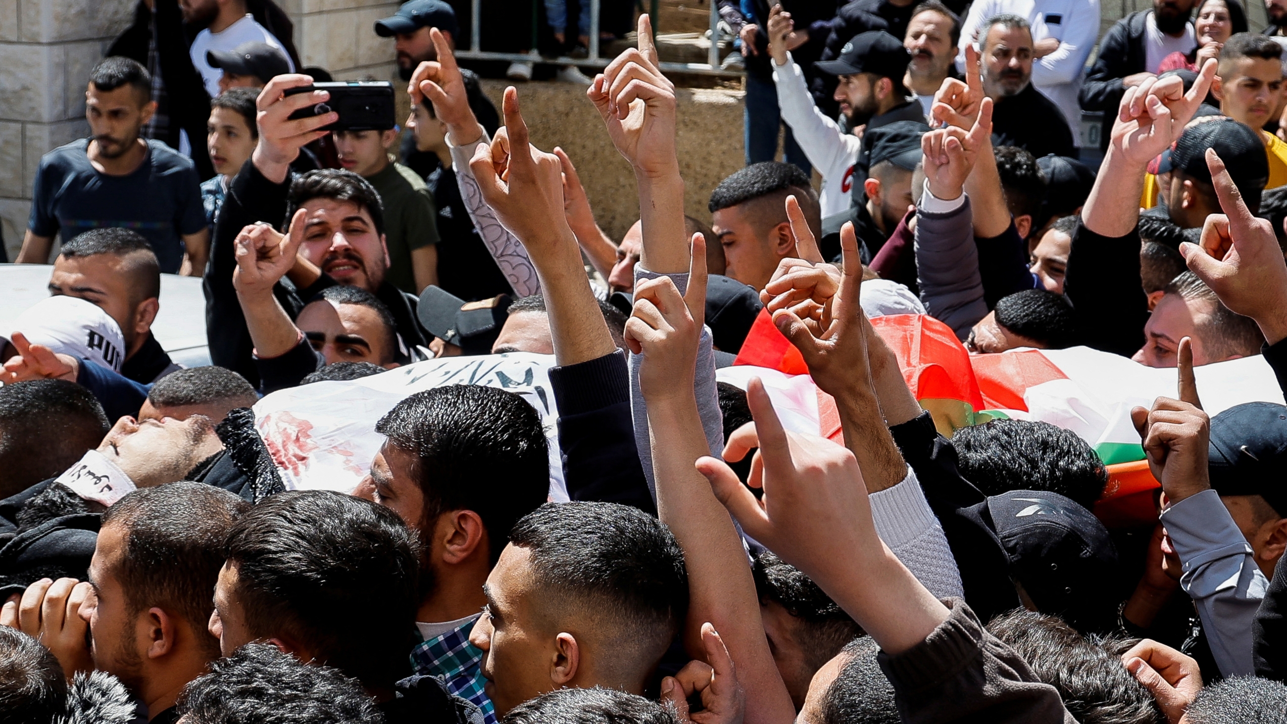 Mourners carry the body of a Palestinian who was killed by Israeli troops during a raid, at a funeral in Nablus on 3 April 2023 (Reuters)