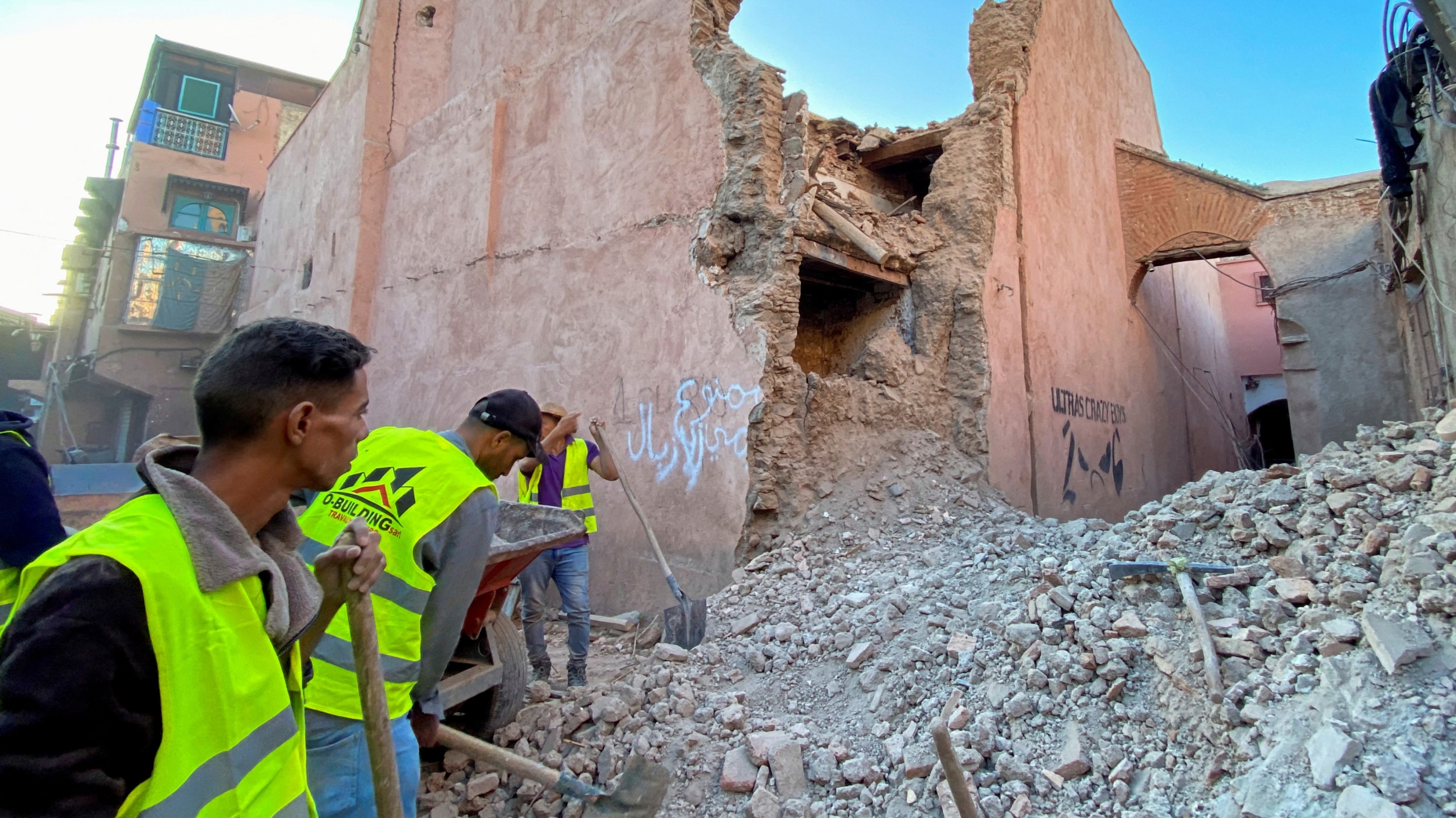 People work next to damage in the historic city of Marrakech, following a powerful earthquake in Morocco, 9 September 2023 (Reuters)