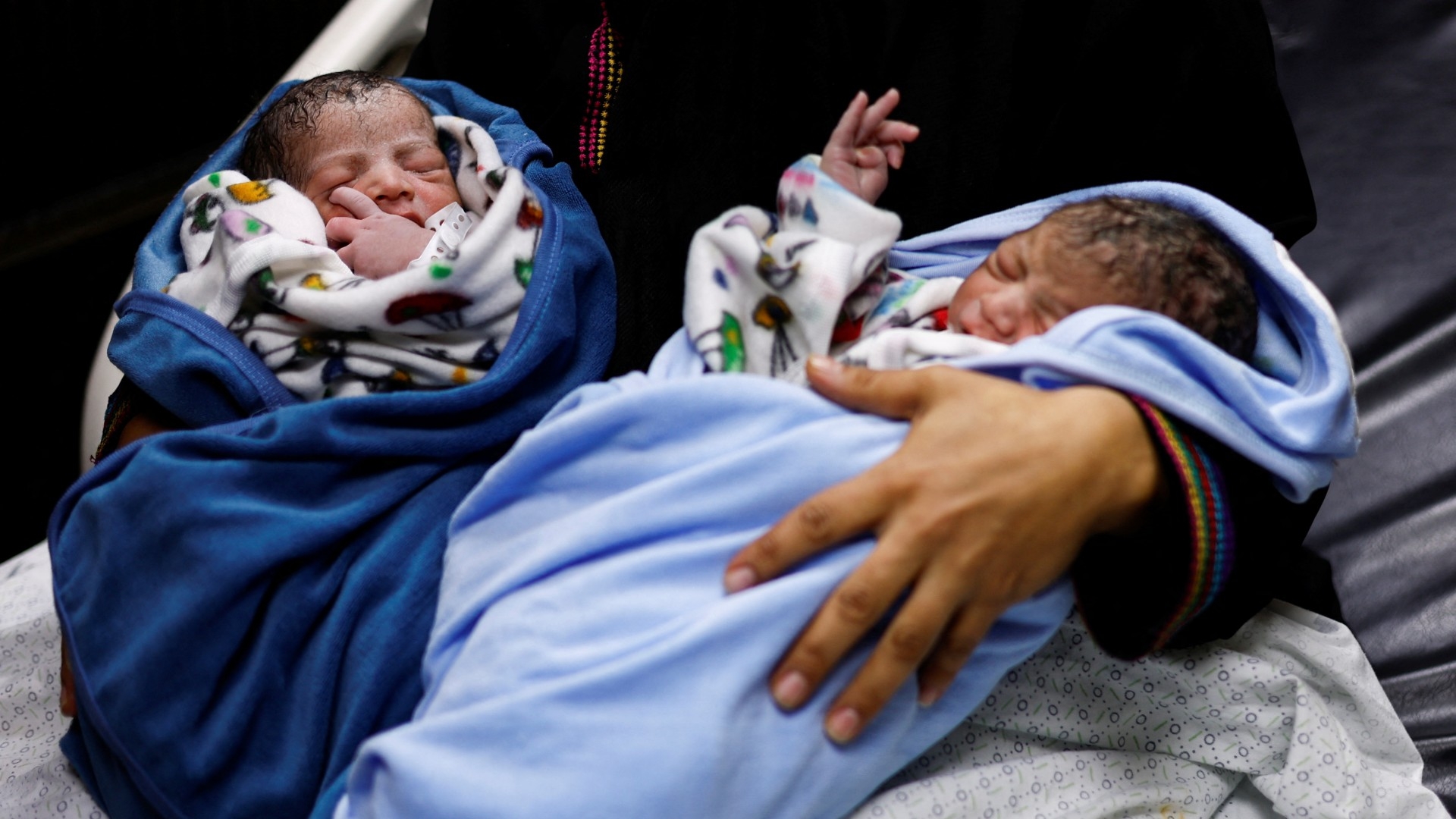 A Palestinian woman Iman holds her newborn twins in Khan Younis in the southern Gaza Strip, 2 November (Reuters)