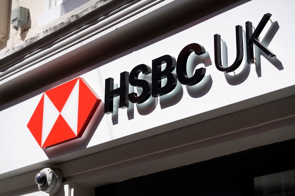 A sign is pictured above a branch of a HSBC bank in central London on April 26, 2022