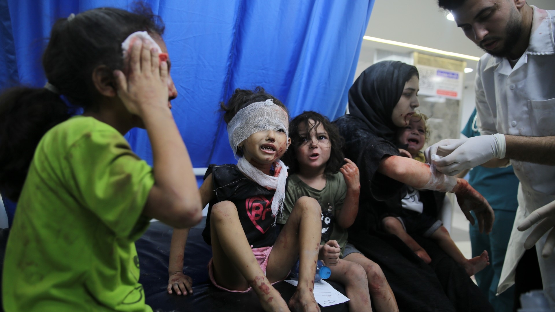 Palestinian children wounded in Israeli strikes are brought to Shifa Hospital in Gaza City on 11 October (AP)