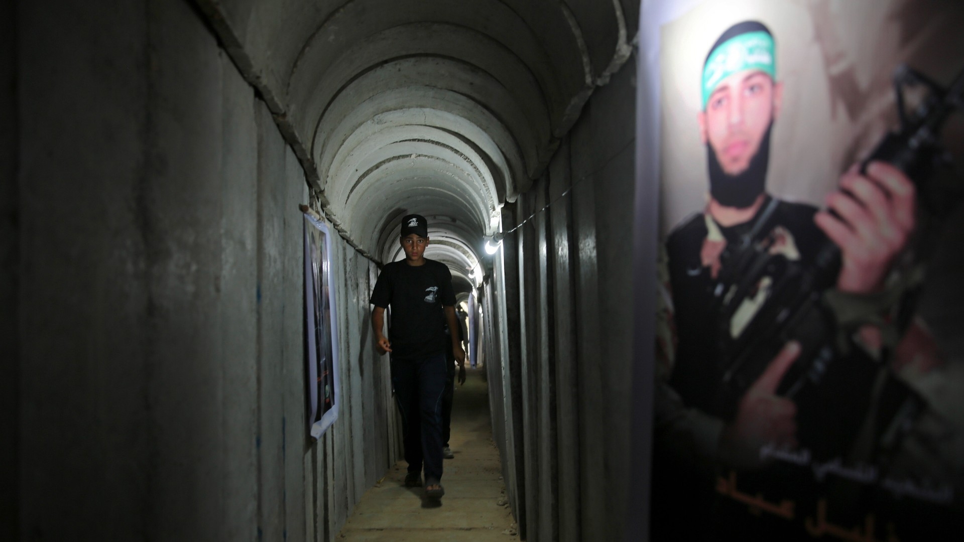 A Palestinian youth walks inside a tunnel used for Hamas military exercises in Gaza City in 2016 (File photo/AP)