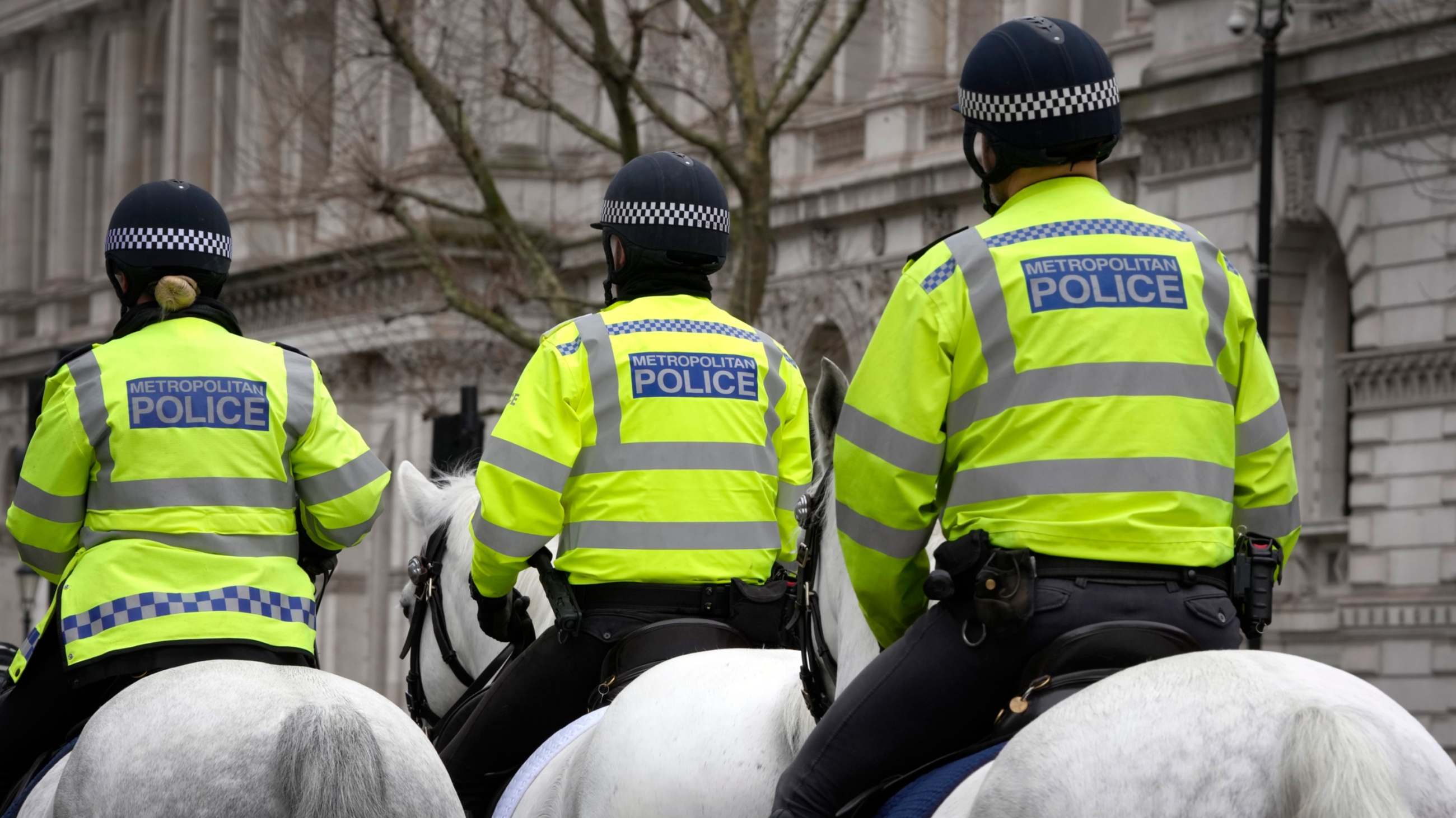 British police officers ride in Westminster in London, 21 March 2023 (AP)