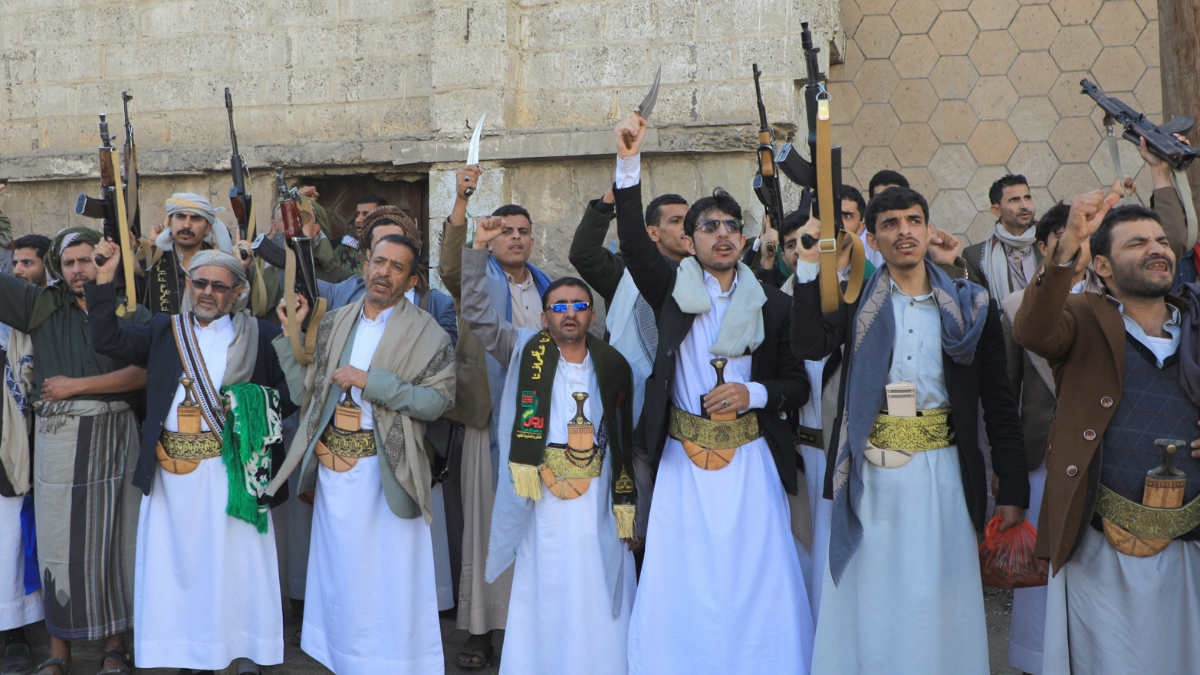 Yemenis lift their guns during a march in solidarity with the people of Gaza in the Houthi-controlled capital Sanaa on 1 December 2023.