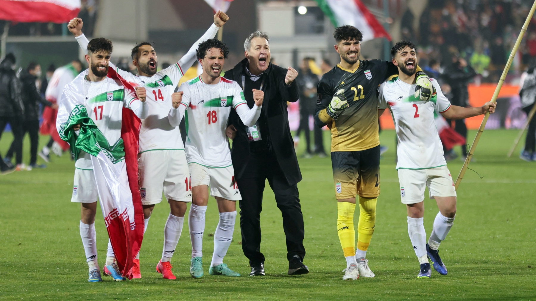Iran's players celebrate with their fans after qualifying for the 2022 Qatar World Cup after their win against Iraq in the Asian Qualifiers football match at the Azadi Sports Complex Tehran, on January 27, 2022 (AFP)
