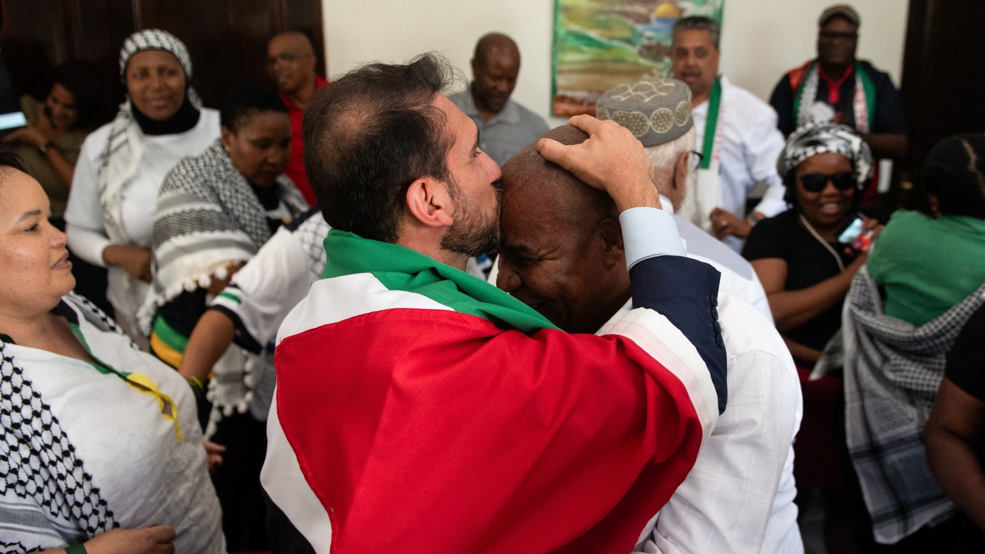 Pro-Palestinian supporters react after the judgement of the ICJ, at the headquarters of the Palestinian mission in Pretoria, South Africa (Reuters/Alet Pretorius)