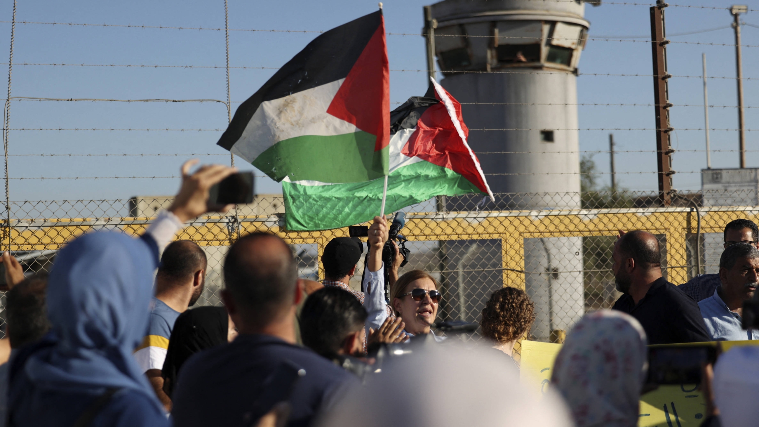 Palestinians demonstrate in front of the Israeli Ofer prison near the city of Ramallah in the occupied West Bank, on 12 July 2021 (AFP)