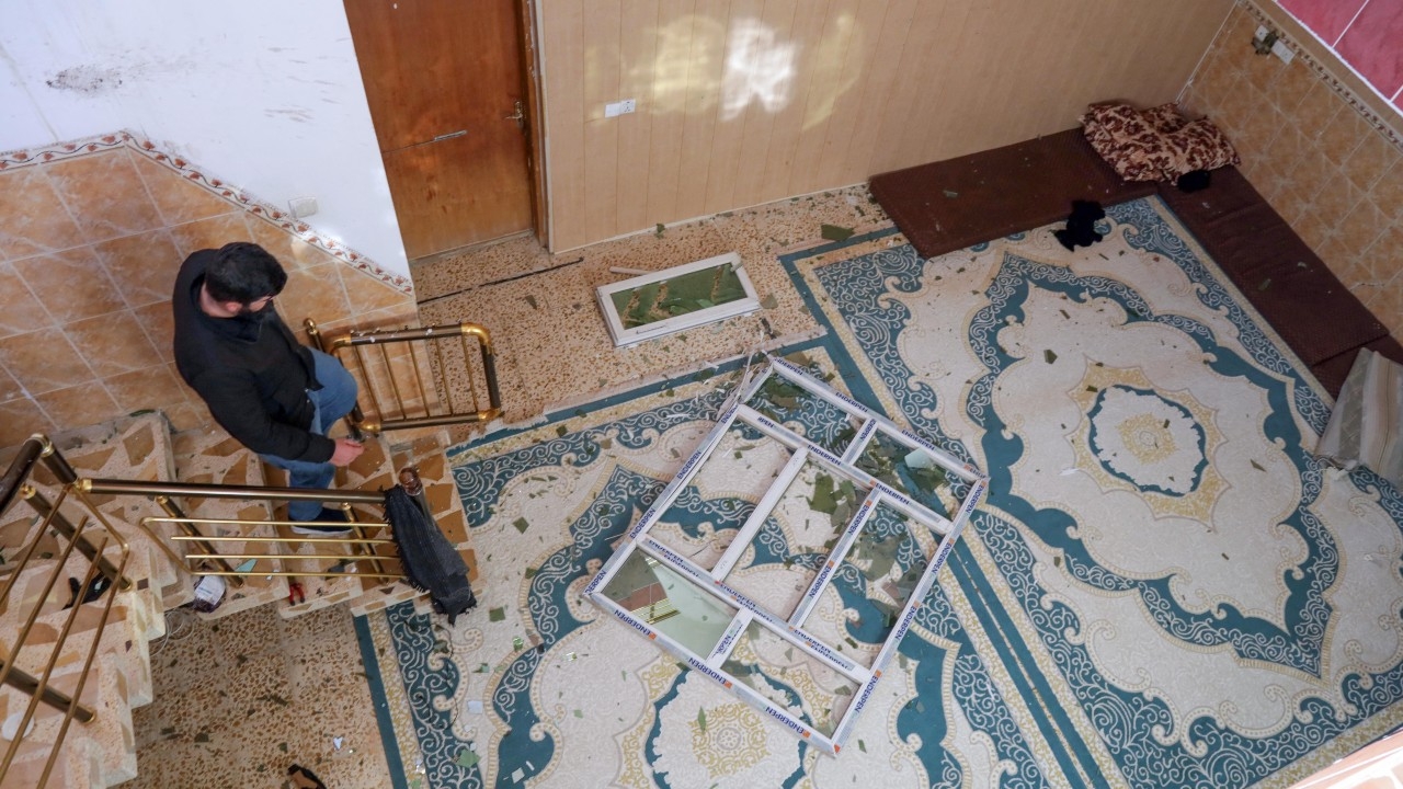 A man inspects the damage at a home following a missile strike launched by Iran's Revolutionary Guard Corps (IRGC) on the Kurdistan Region’s capital of Erbil on 16 January (AFP)