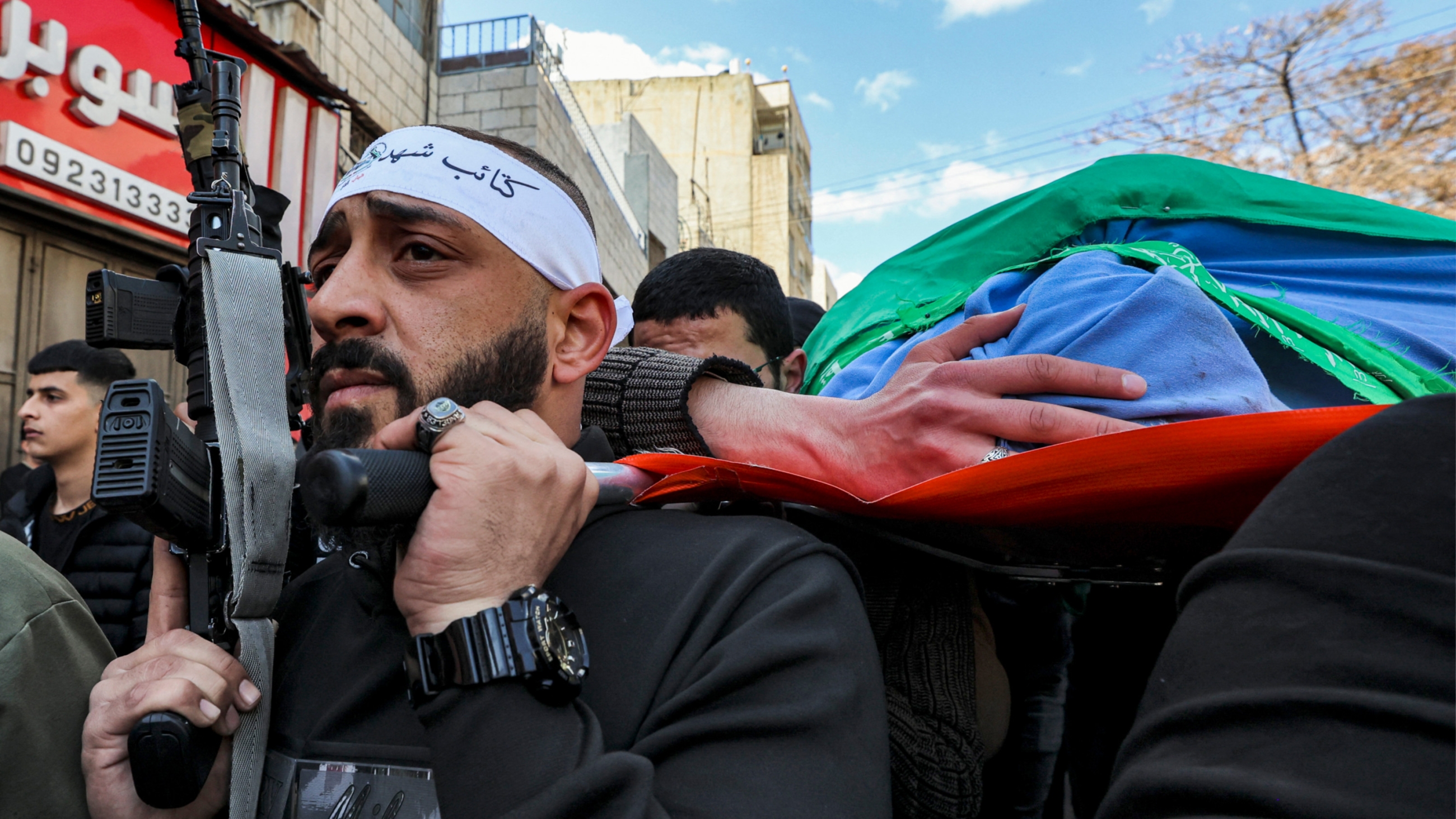 Mourners march with the body of Abdel Fatah Hussein Khroushah, 49, who was killed in an Israeli raid on Jenin refugee camp, 8 March 2023 (AFP)