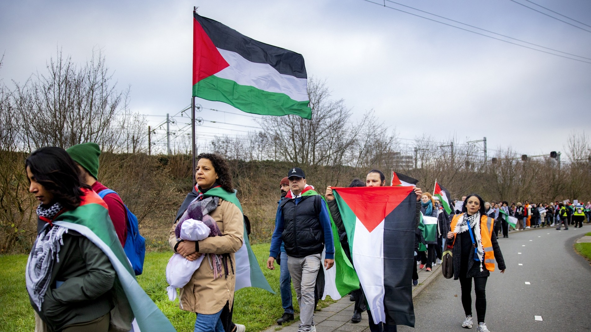 Participants attend a march from Leiden to the International Criminal Court in The Hague, in solidarity with Palestinians of the Gaza Strip, in Leiden, on 17 December, 2023 (AFP)
