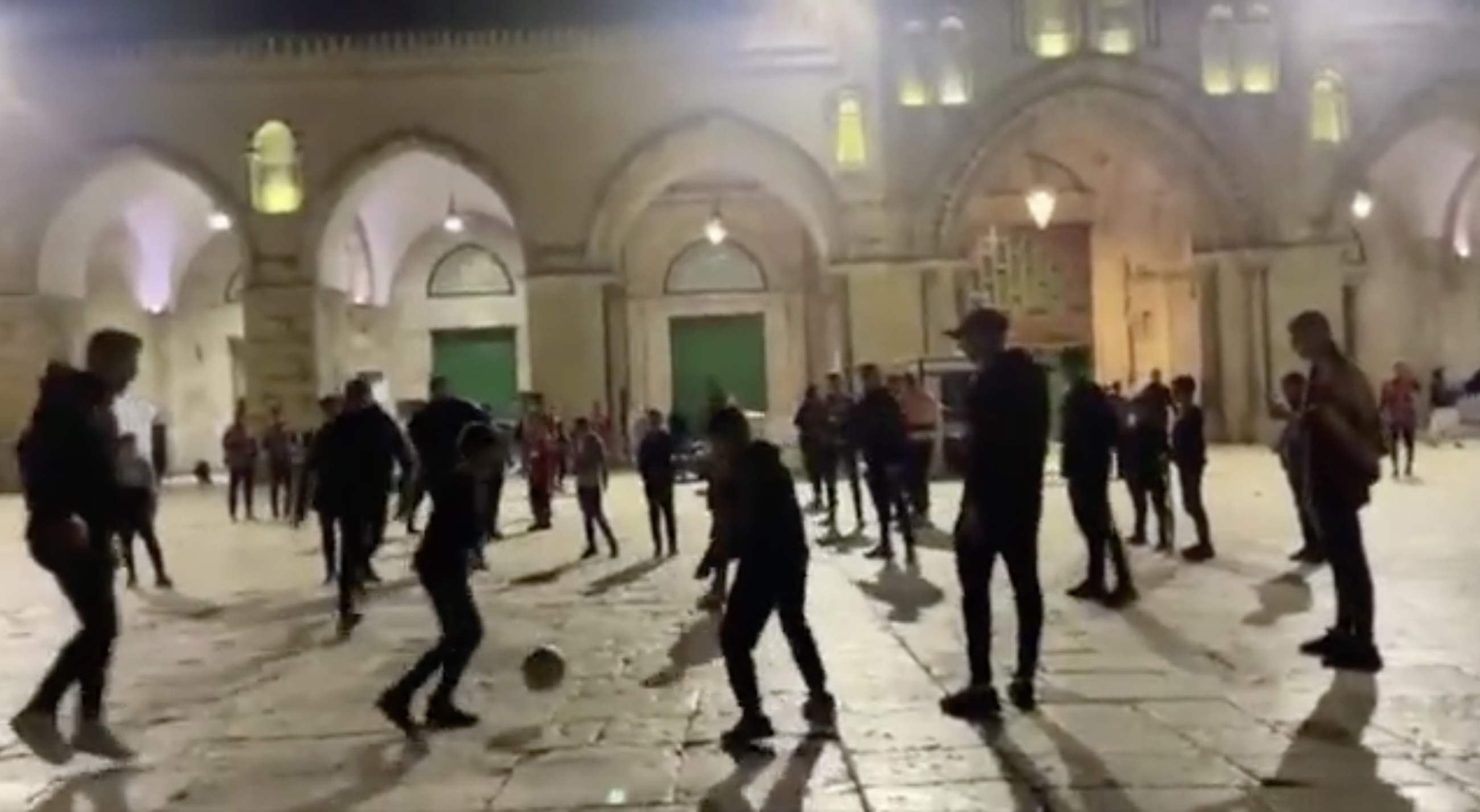 Palestinian teens play soccer outside Al-Aqsa Mosque (Screenshot from social media) 