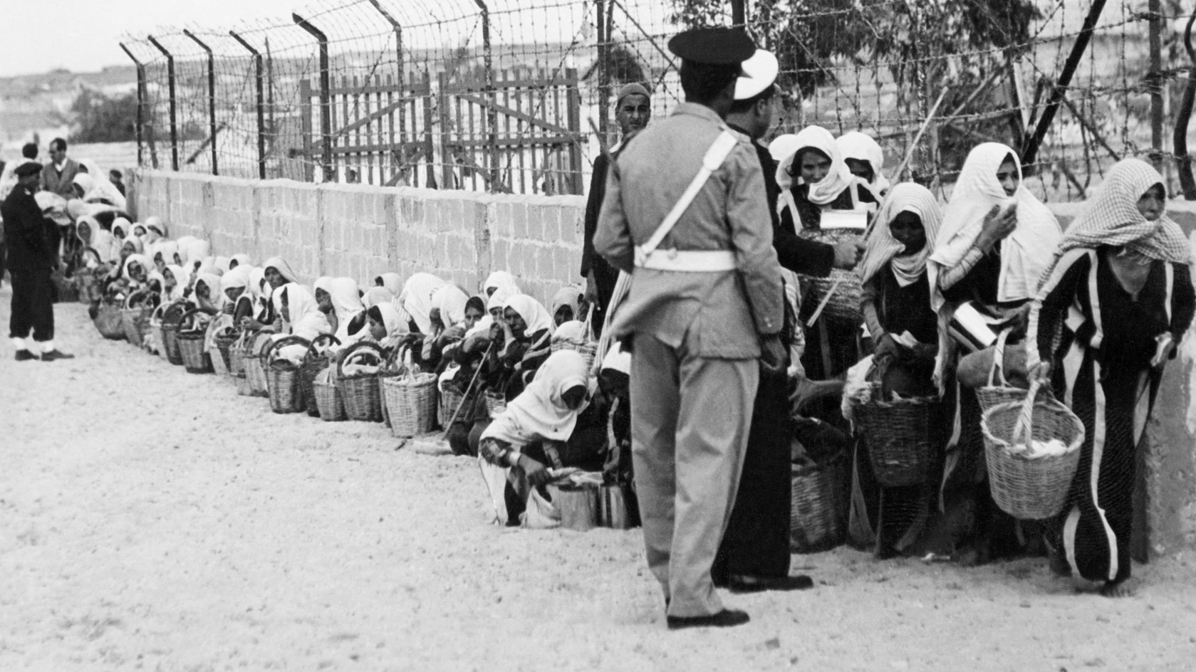 Palestinian refugees queue for food distributed by the Unrwa (UN Relief and Work Agency for Palestinian refugees) at a camp in Gaza 09 November 1956 (Rene Jarland/AFP)