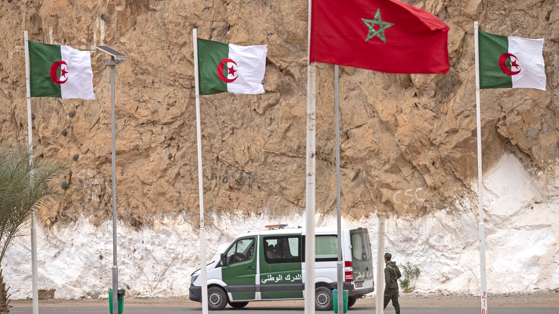 A picture taken from the Moroccan region of Oujda shows Algerian border guards patrolling along the border with Morocco on 4 November 2021 (AFP/File photo)