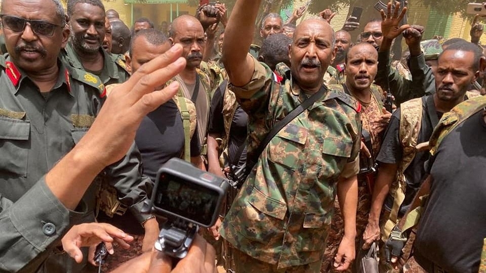 Sudan's General Abdel Fattah al-Burhan stands among troops, in an unknown location, in this picture released on 30 May 2023 (Reuters)
