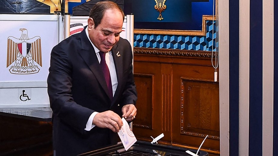 A handout picture released by the Egyptian Presidency on 10 December 2023, shows Egyptian president Abdel Fattah al-Sisi casting his vote in the presidential election at Mustafa Yousry Emmera School in Cairo (AFP)