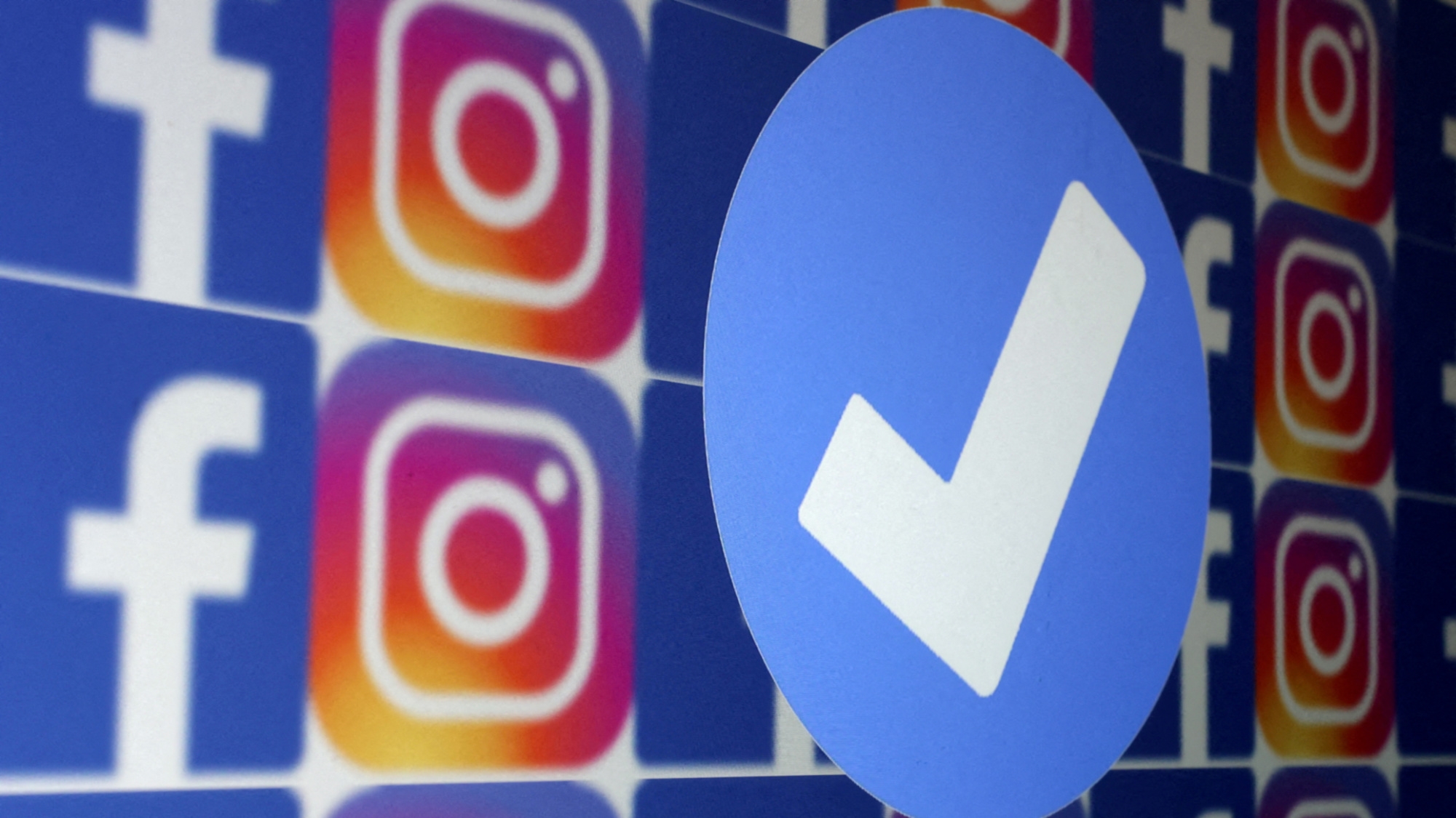 A blue verification badge and the logos of Facebook and Instagram are seen in this picture illustration taken 19 January 2023 (Reuters/Dado Ruvic)