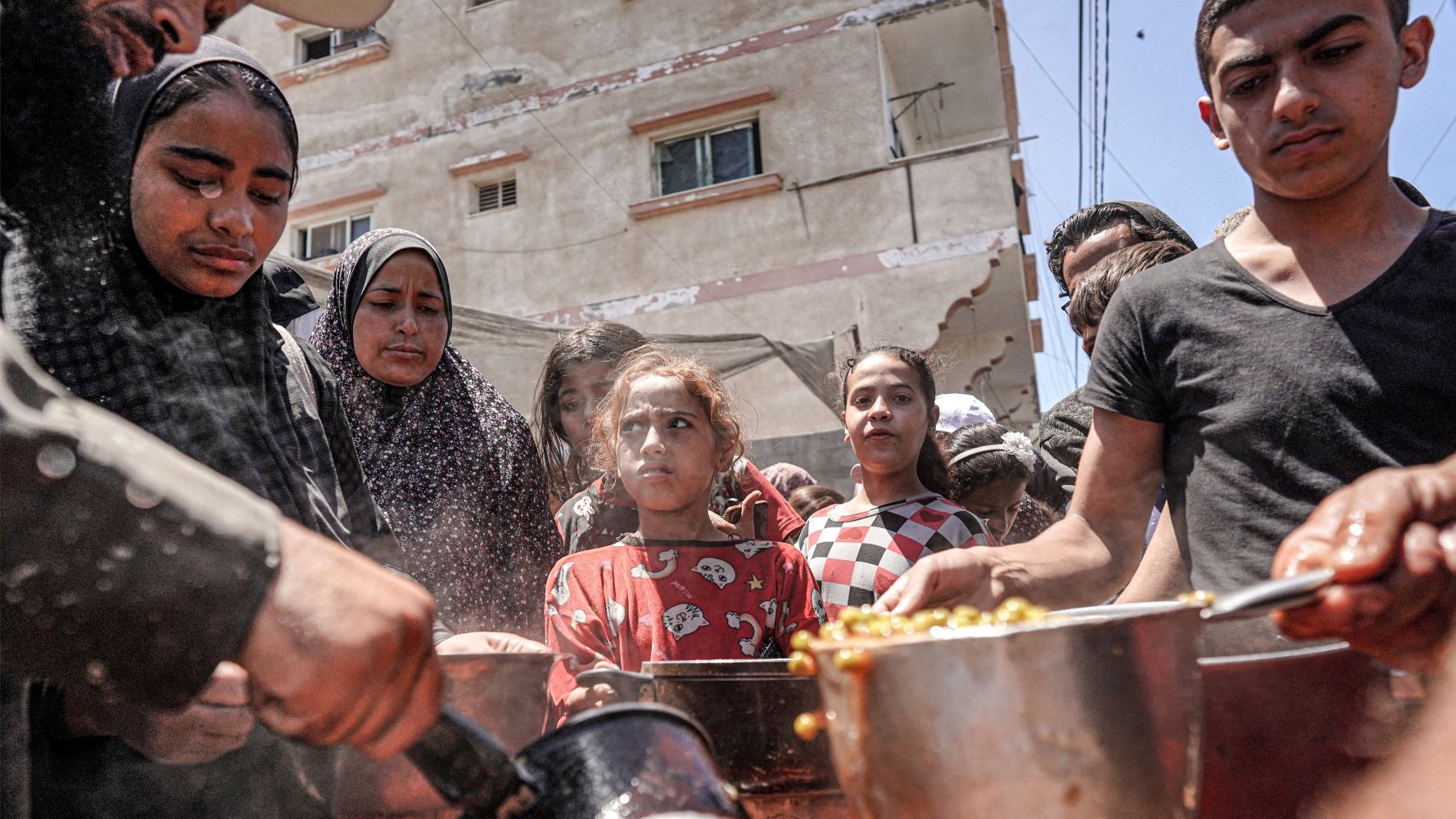 Palestinians in Deir al-Balah in central Gaza prepare food on 13 May (AFP)