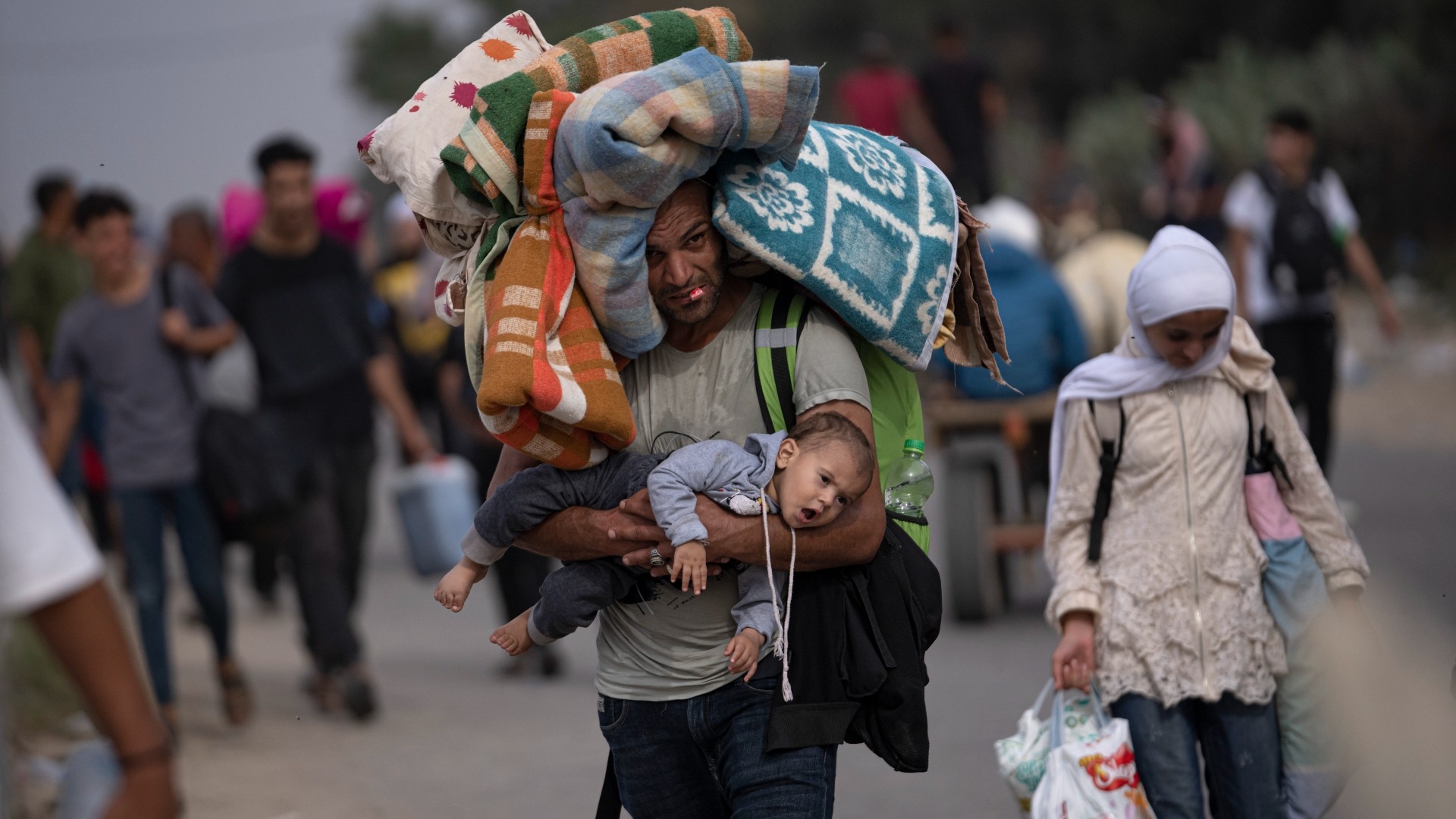 Palestinians flee to the southern Gaza Strip on Salah al-Din Street in Bureij, Gaza Strip, Saturday, Nov. 11, 2023. 