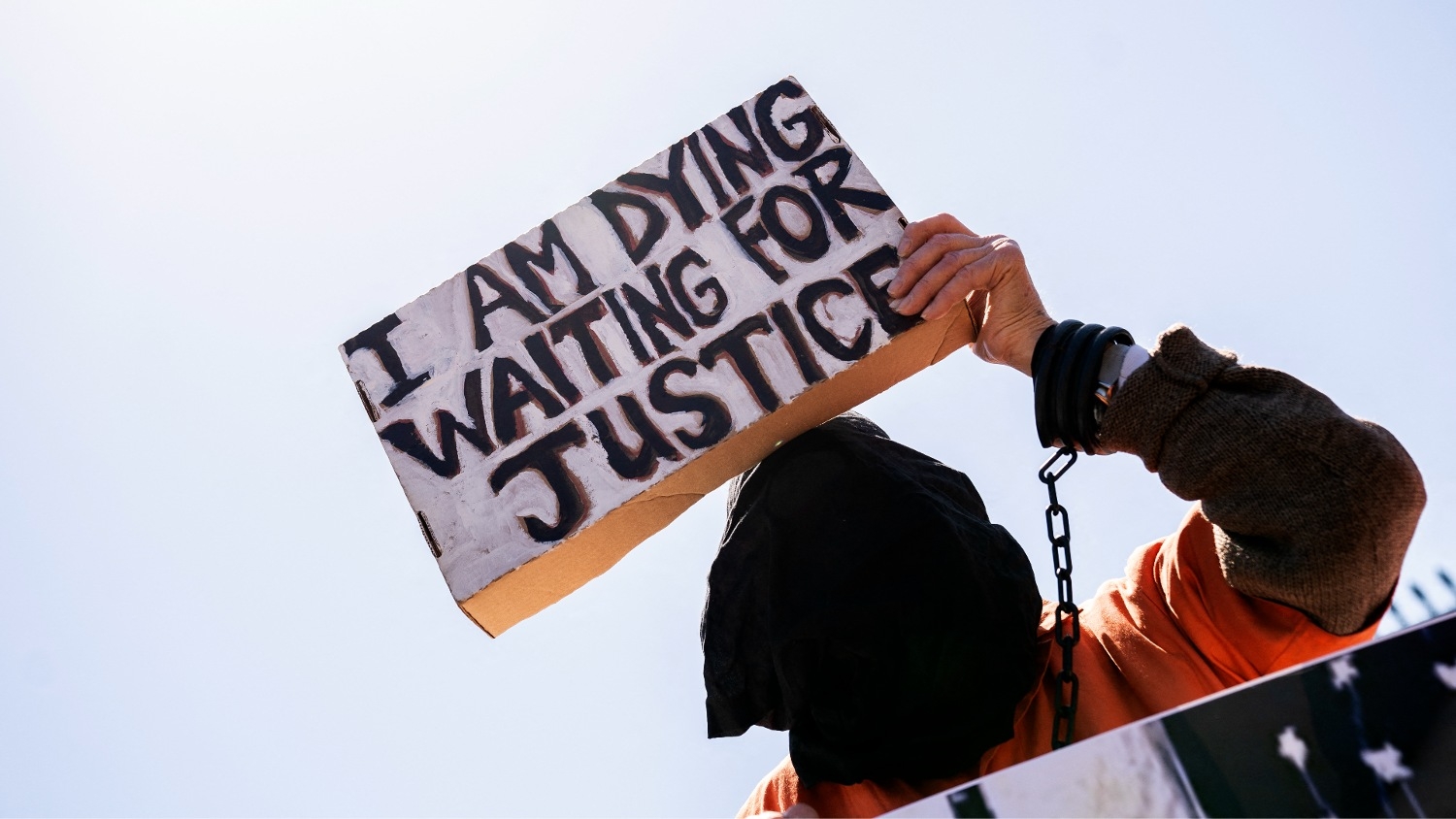 A demonstrator calling for the closure of the Guantanamo Bay detention facility holds a sign in front of the White House in Washington on 2 April 2022.