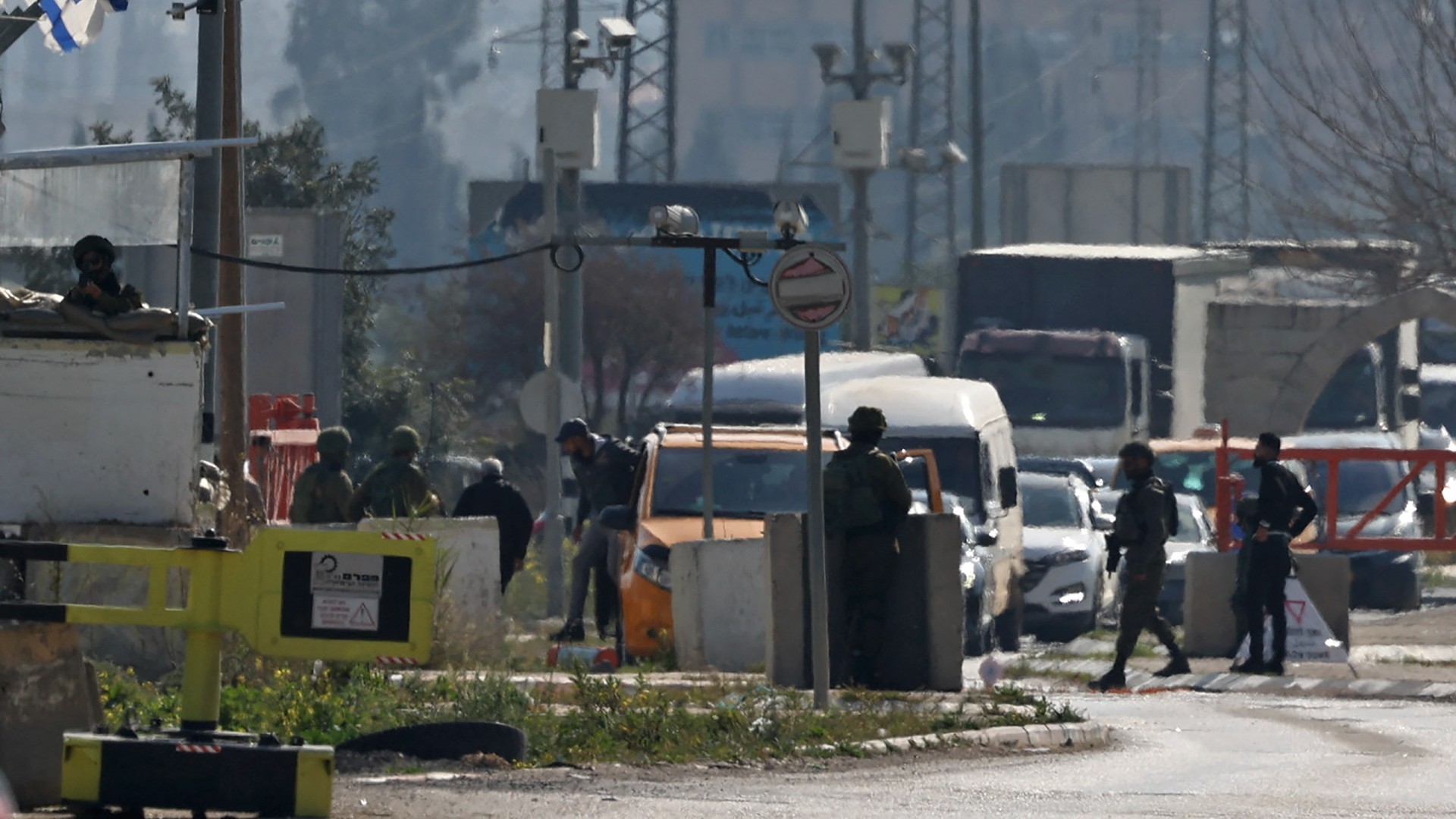 Israeli security forces search vehicles at the Hawara checkpoint, the southern entrance to Nablus city, in the occupied West Bank on 26 February 2023 (AFP)