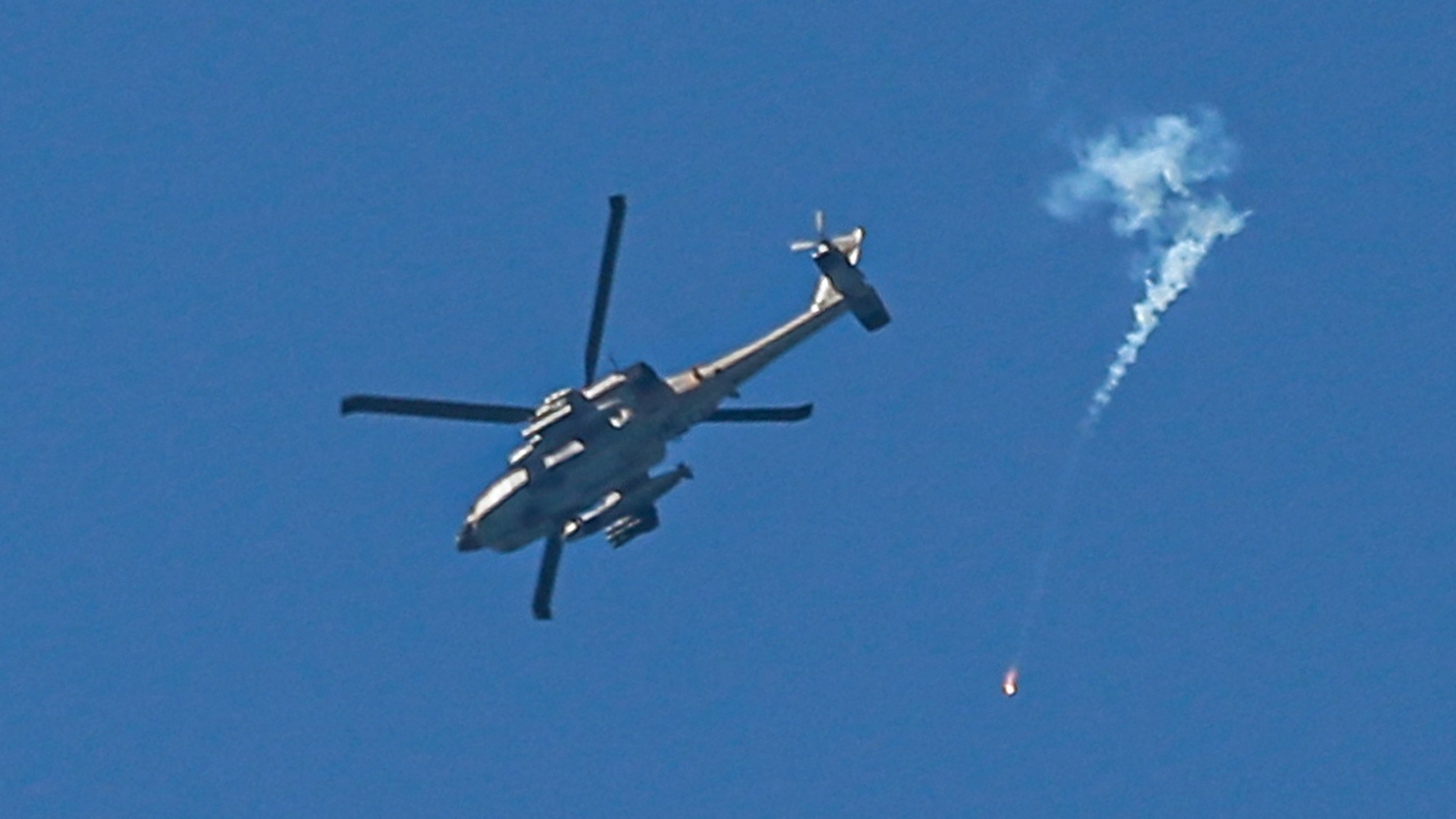 An Israeli helicopter fires flares over central Gaza in April (AFP)