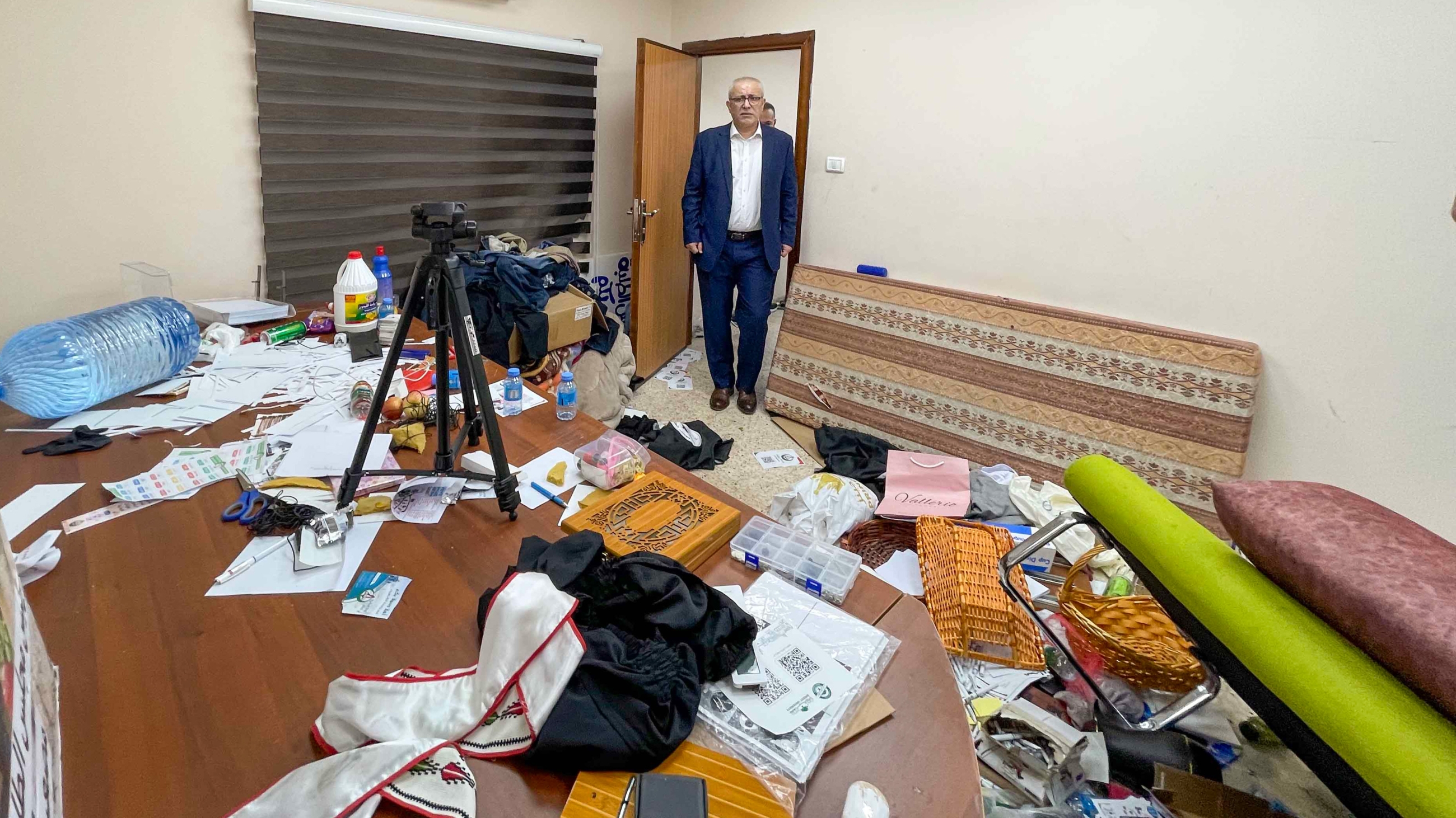 Birzeit University staff inspect damage left to student council office after an Israeli raid on 24 September 2023 (Birzeit University)