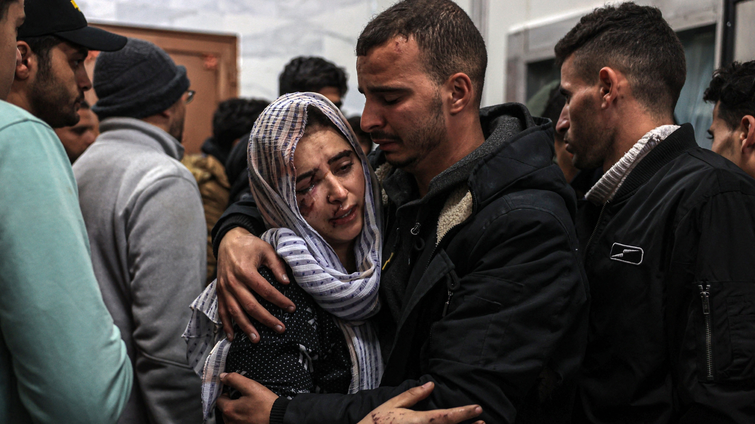 Injured relatives of Palestinians killed during Israeli strikes mourn at the EU hospital in Khan Younis in the southern Gaza Strip on 21 December 2023 (Said Khatib/AFP)
