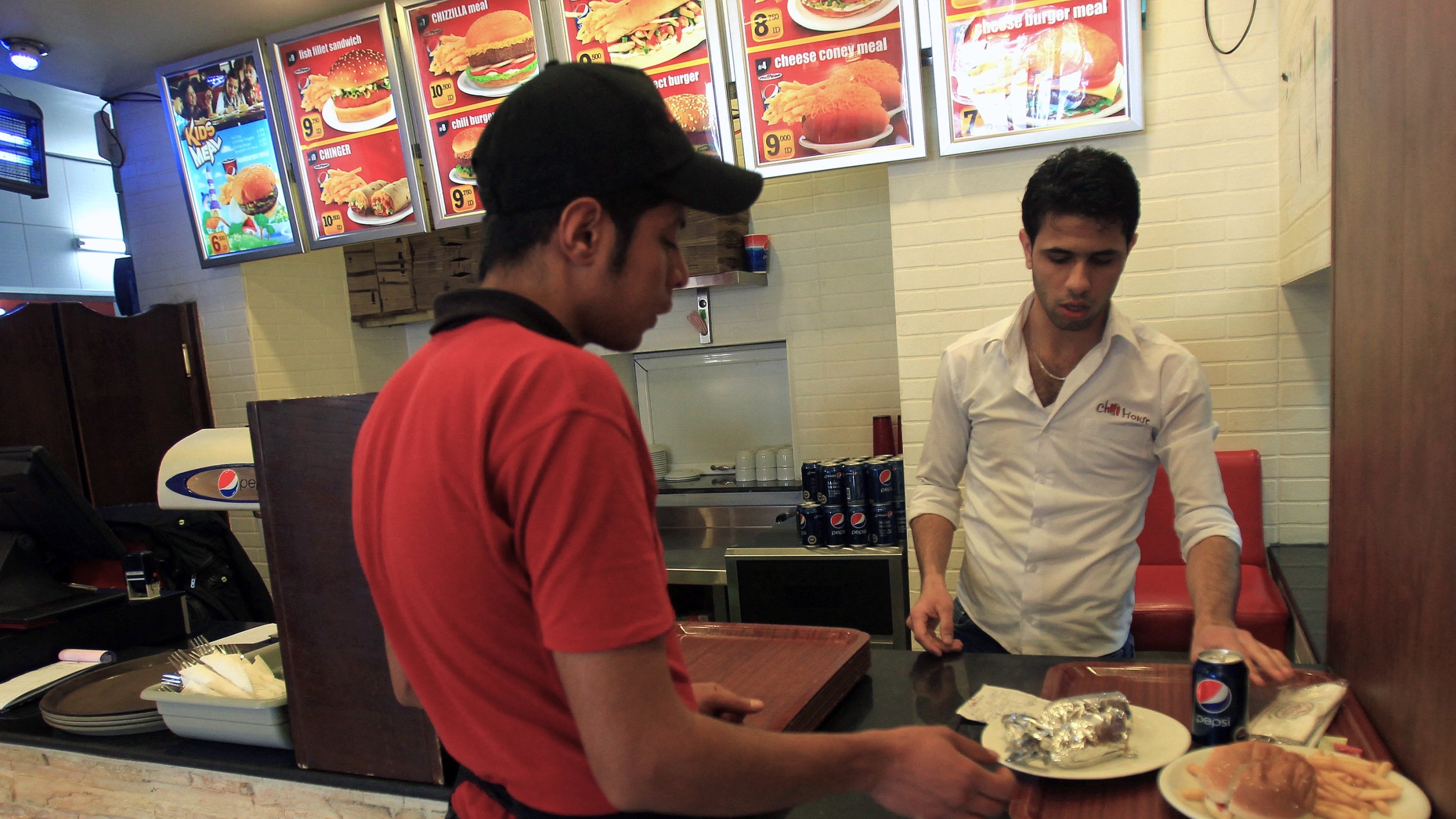 Workers at a fast food outlet in the Iraqi capital Baghdad in 2013 (AFP)