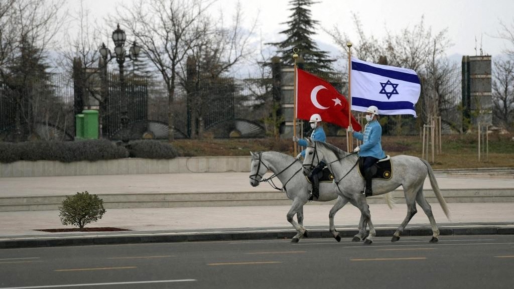 Turkish cavalry guards waving the Israeli and Turkish flags, to welcome the Israeli president in the capital Ankara, 9 March 2022 (AFP)