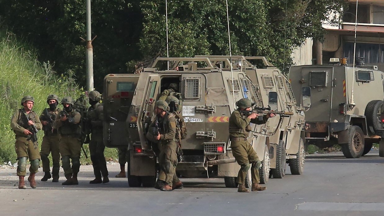 Israeli security officers deploy during a raid to look for wanted Palestinians in Nablus city in the occupied West Bank, on 11 April 2022.