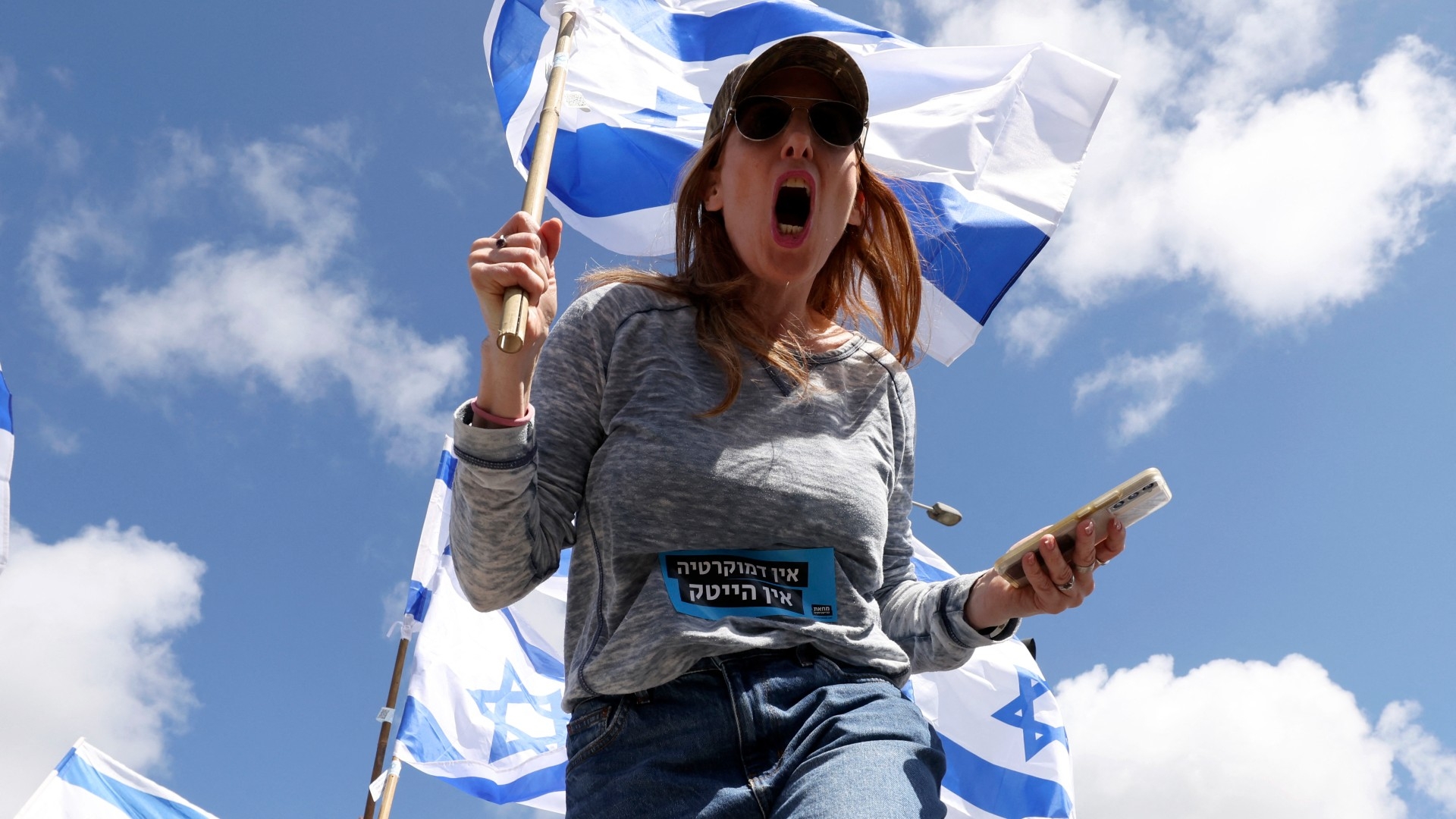 A woman protests against the Israeli government's controversial judicial reform bill in Haifa on 9 March 2023 (AFP)