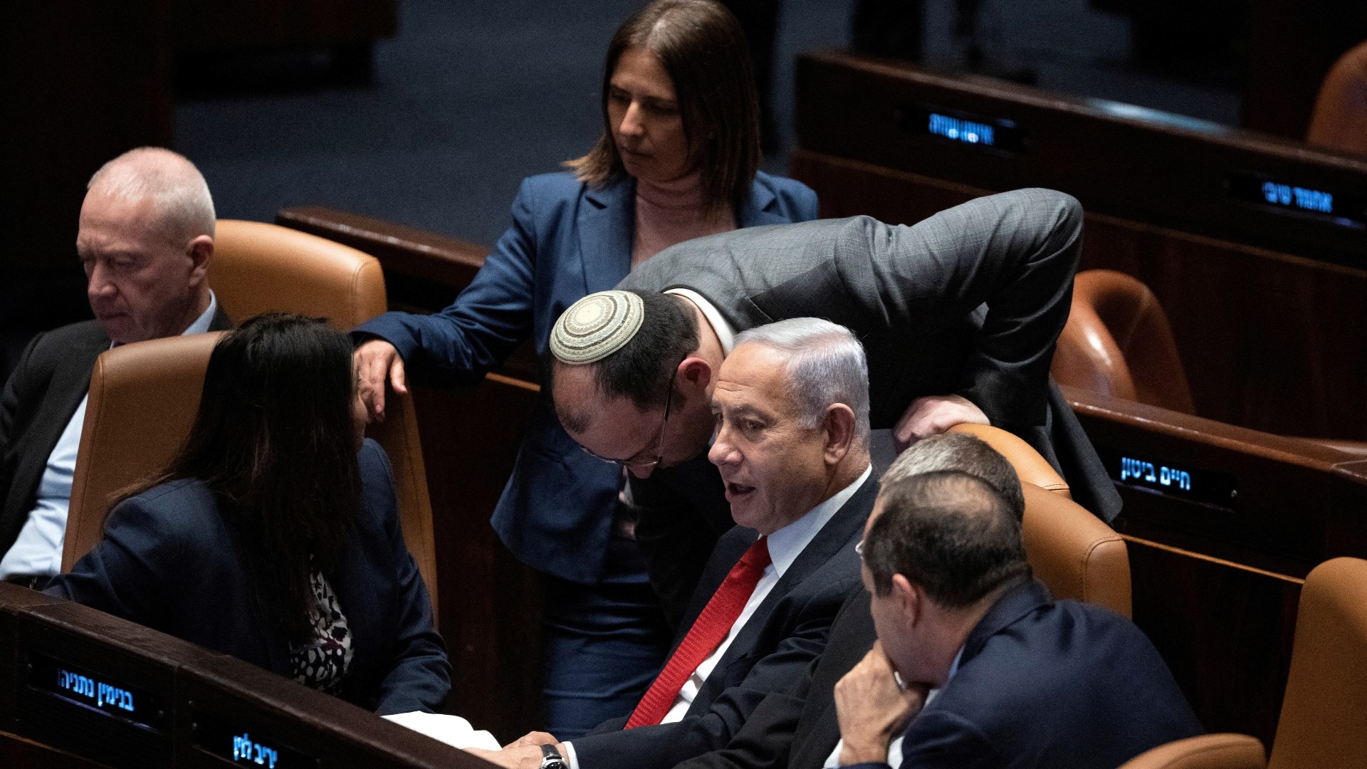 Israel's Prime Minister Benjamin Netanyahu confers with lawmakers as they convene in Israel's parliament in Jerusalem on 20 February 2023 (Reuters)