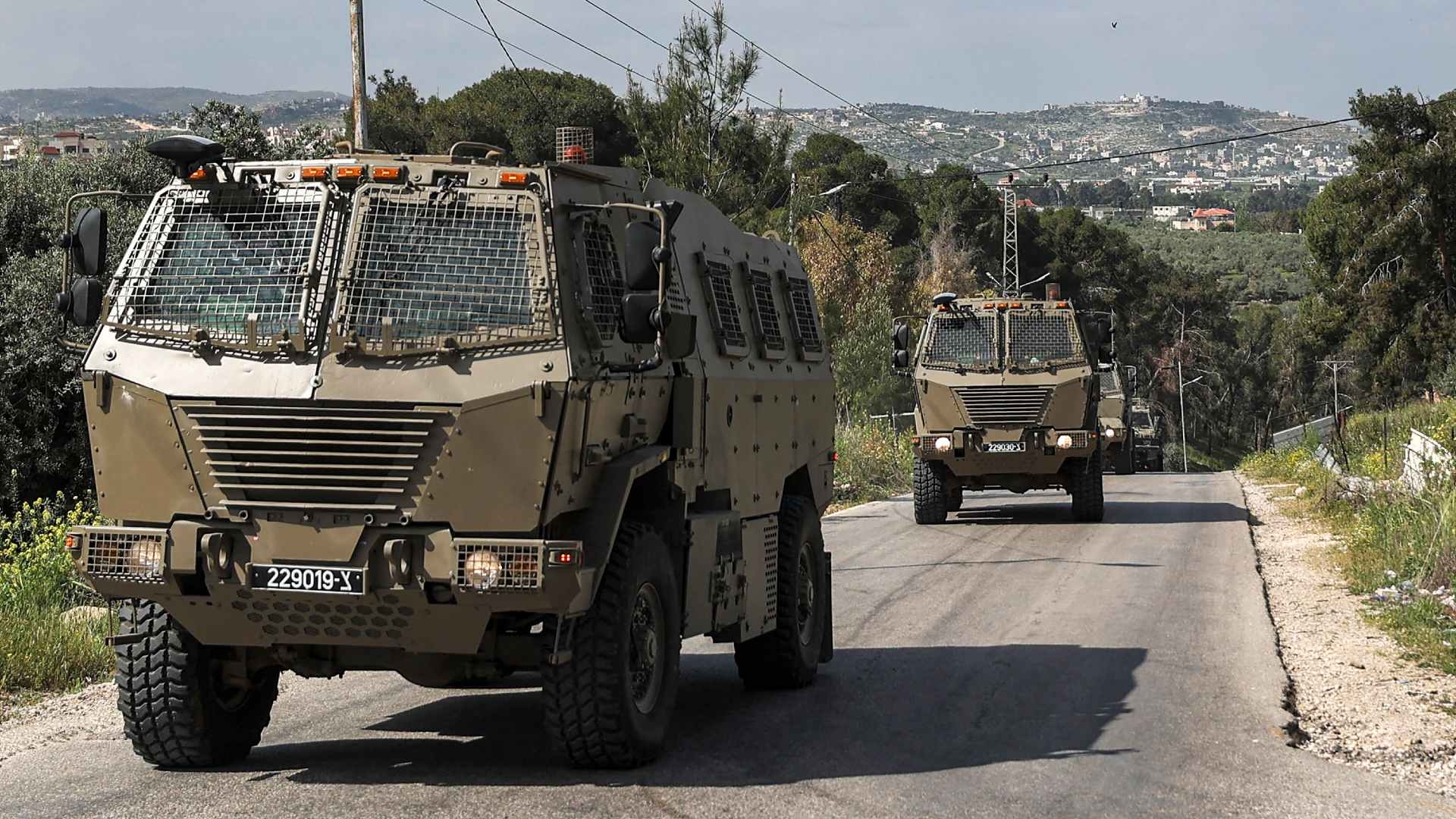 Israeli military vehicles drive during clashes between Palestinians and Israeli forces in the Palestinian refugee camp of Jenin in the occupied West Bank on 9 April 2022.