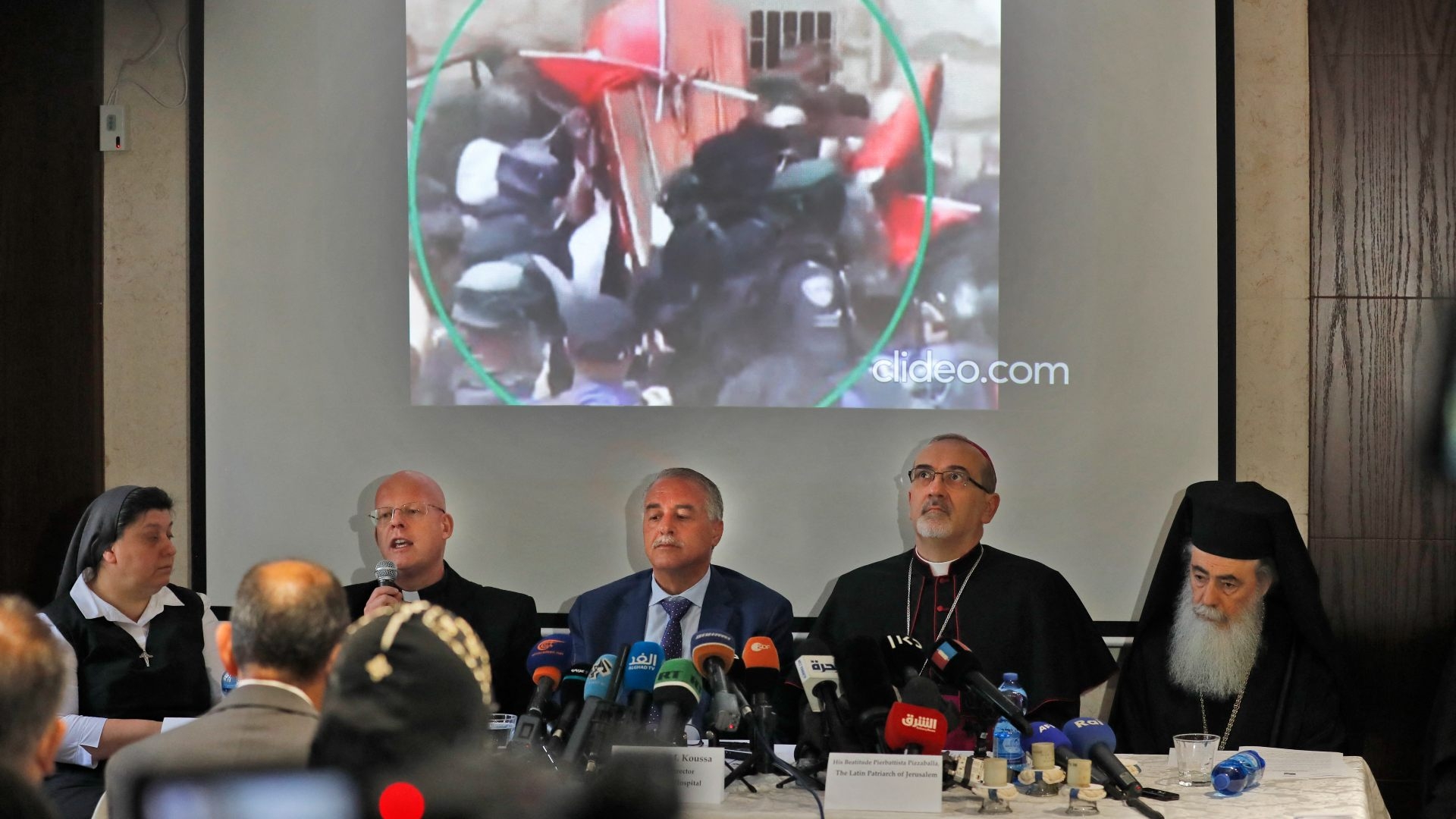 Christian leaders present video footage of scenes in the Saint Joseph's Hospital prior to Abu Akleh's funeral procession during a press conference in Jerusalem on 16 May 2022.