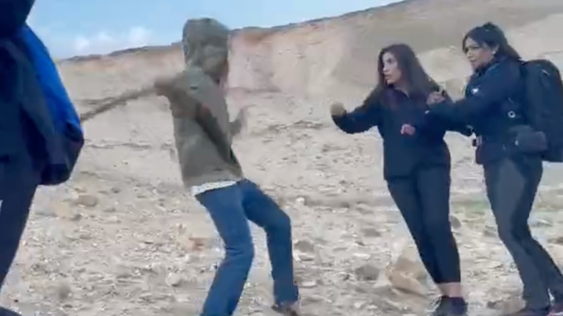 Israeli settler seen on video attacking Palestinian and foreign hikers north of the occupied West Bank city of Jericho on 13 January 2023 (Screengrab)