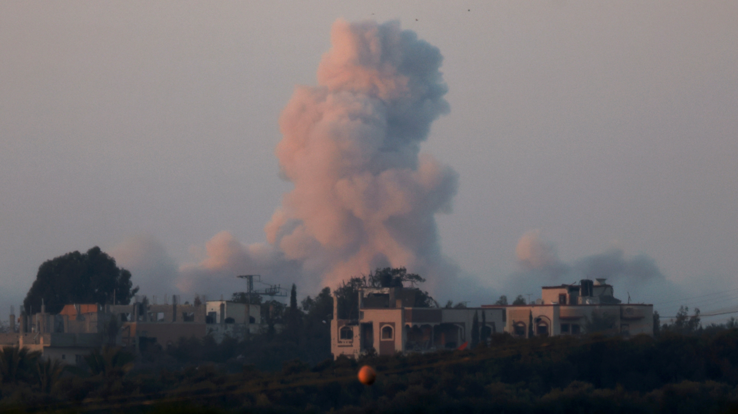 a smoke rises in central gaza